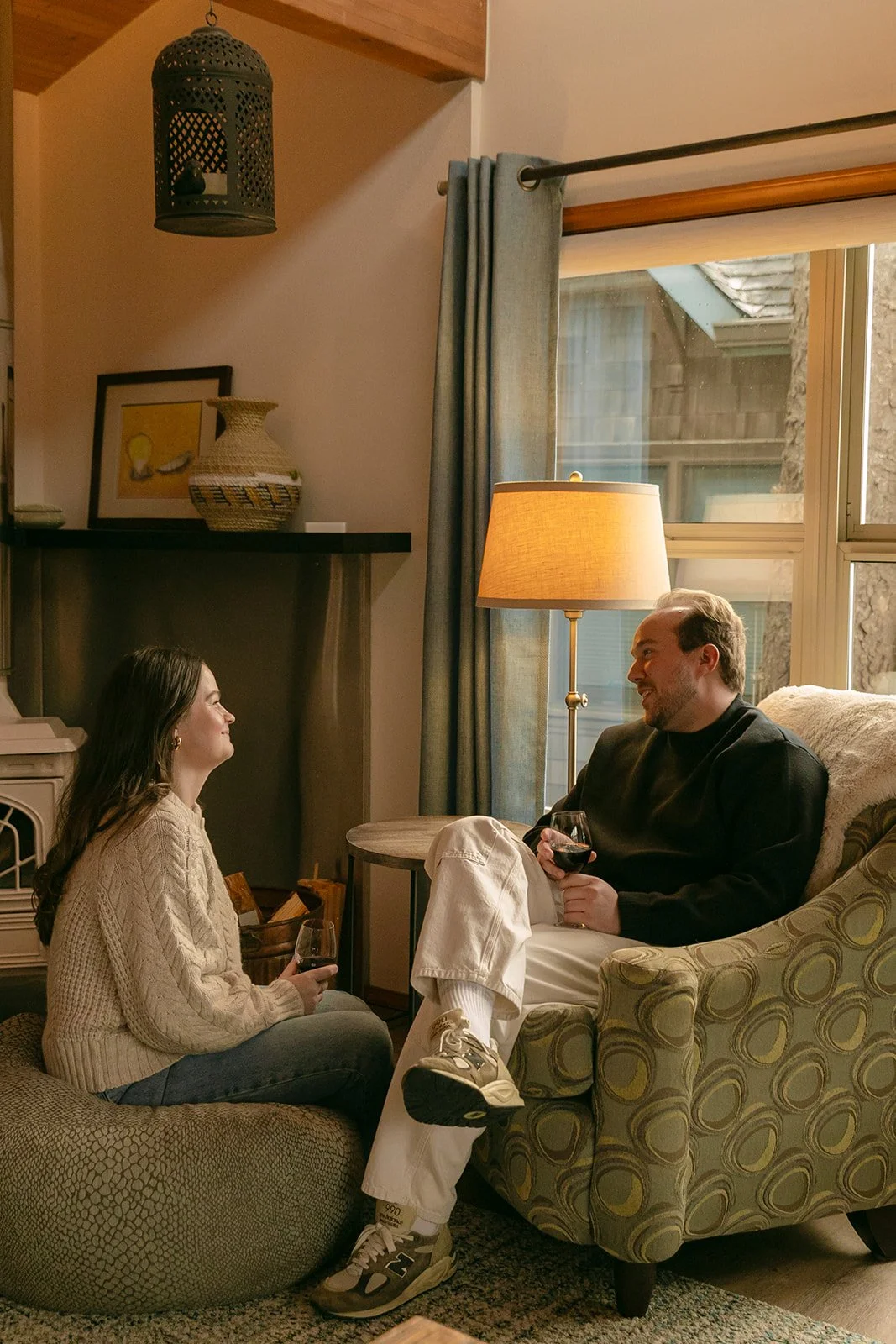 A couple taking indoor engagement photos in a family home after choosing where to take engagement photos