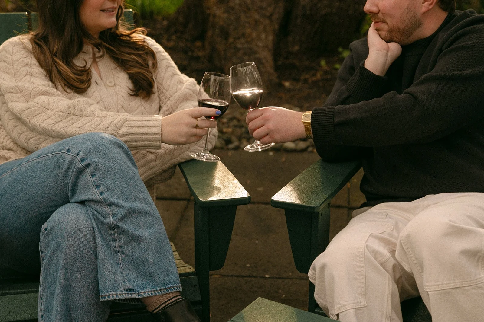 A couple taking romantic engagement photos on a porch of a family home