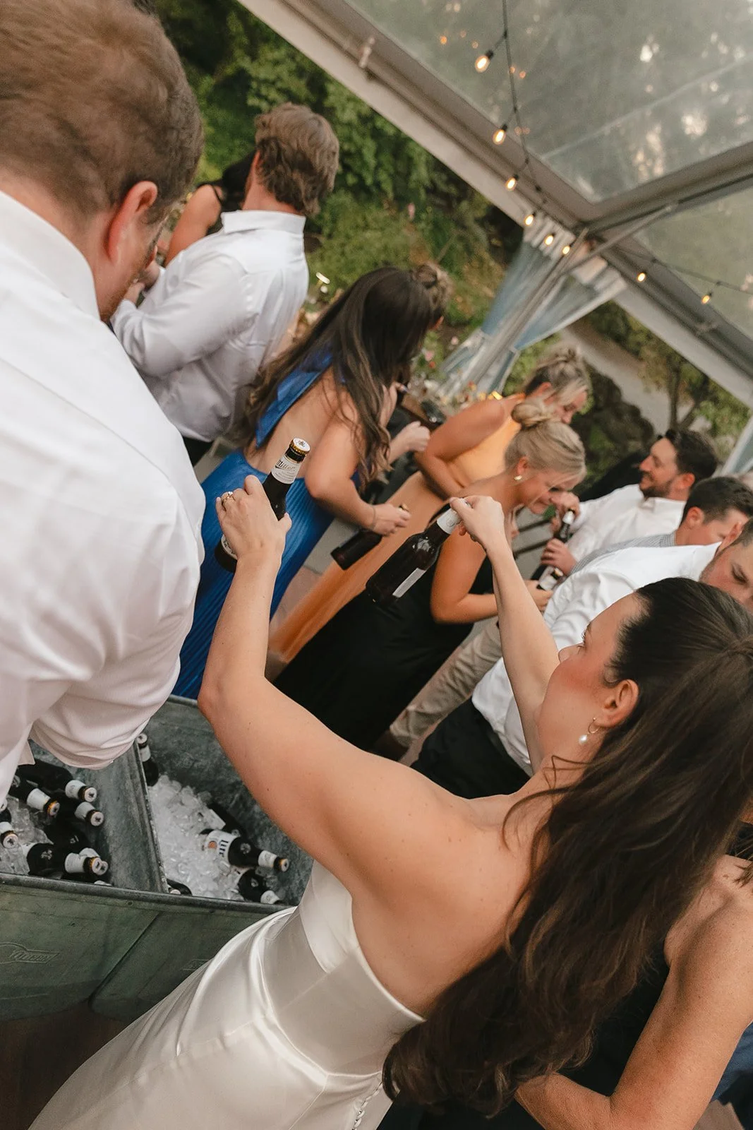 A bride passing out miller lites as a memorial ideas for weddings for her dad
