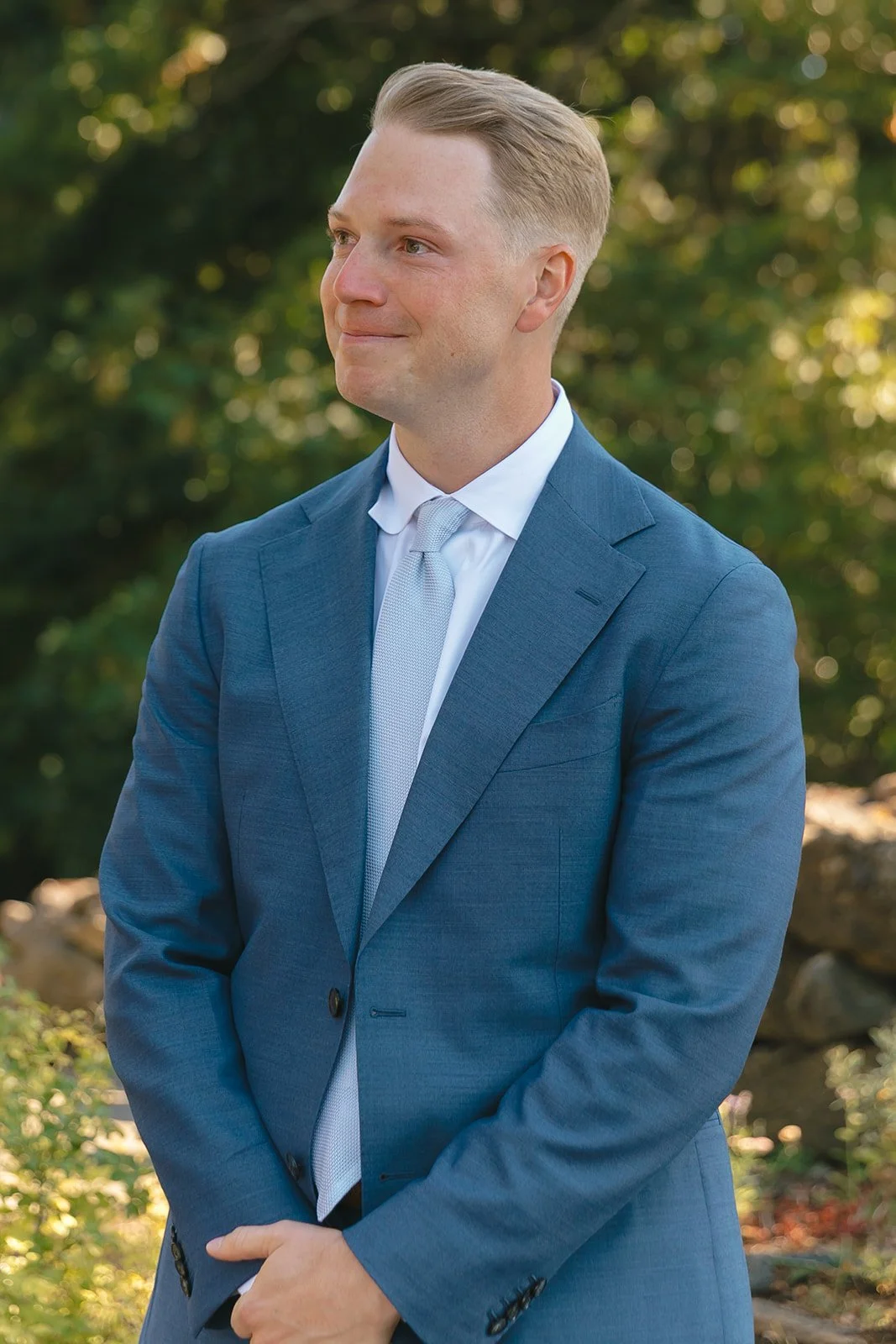 A groom crying while his bride walks down the aisle