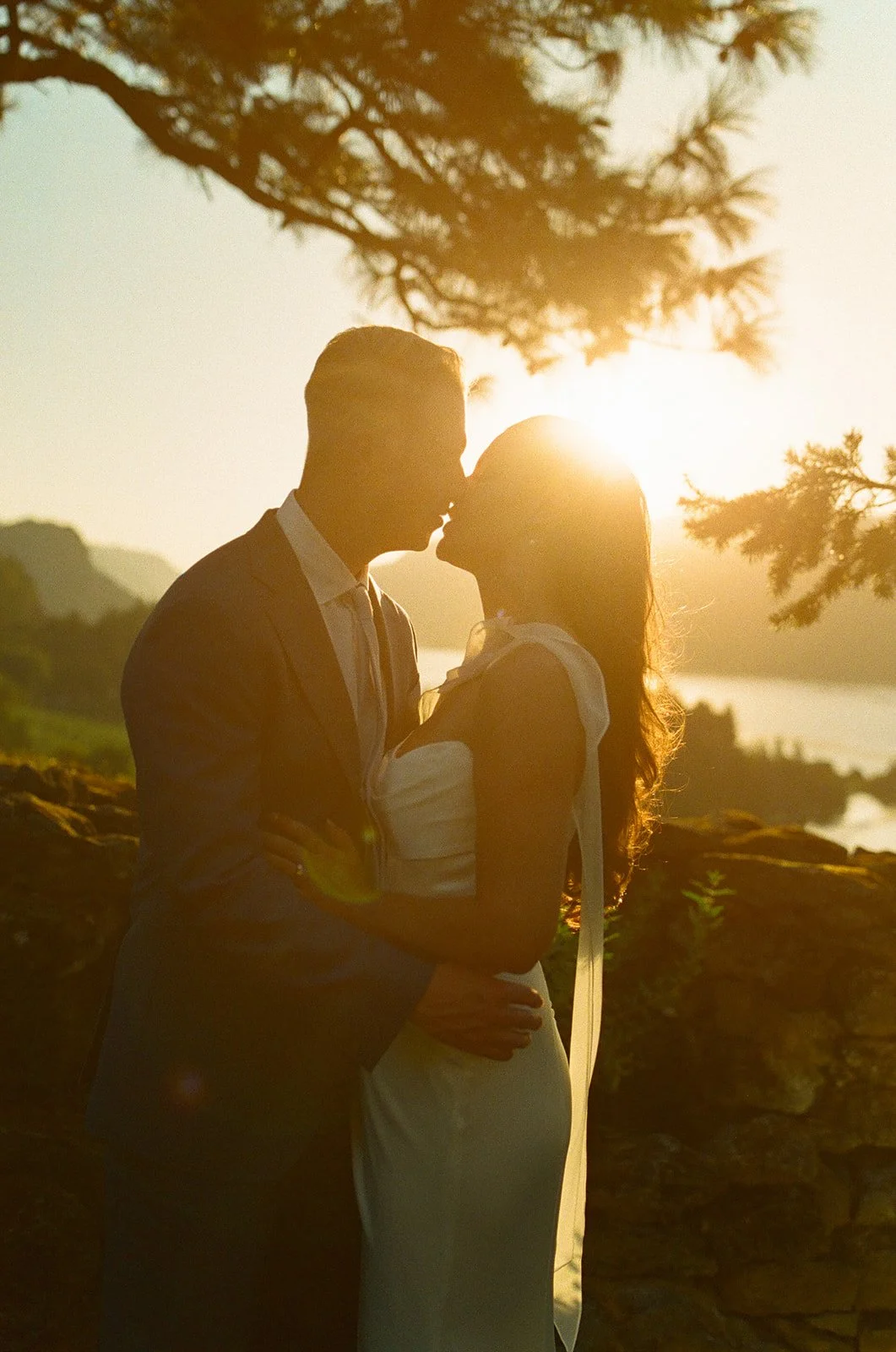 A bride and groom posing for golden hour wedding photos