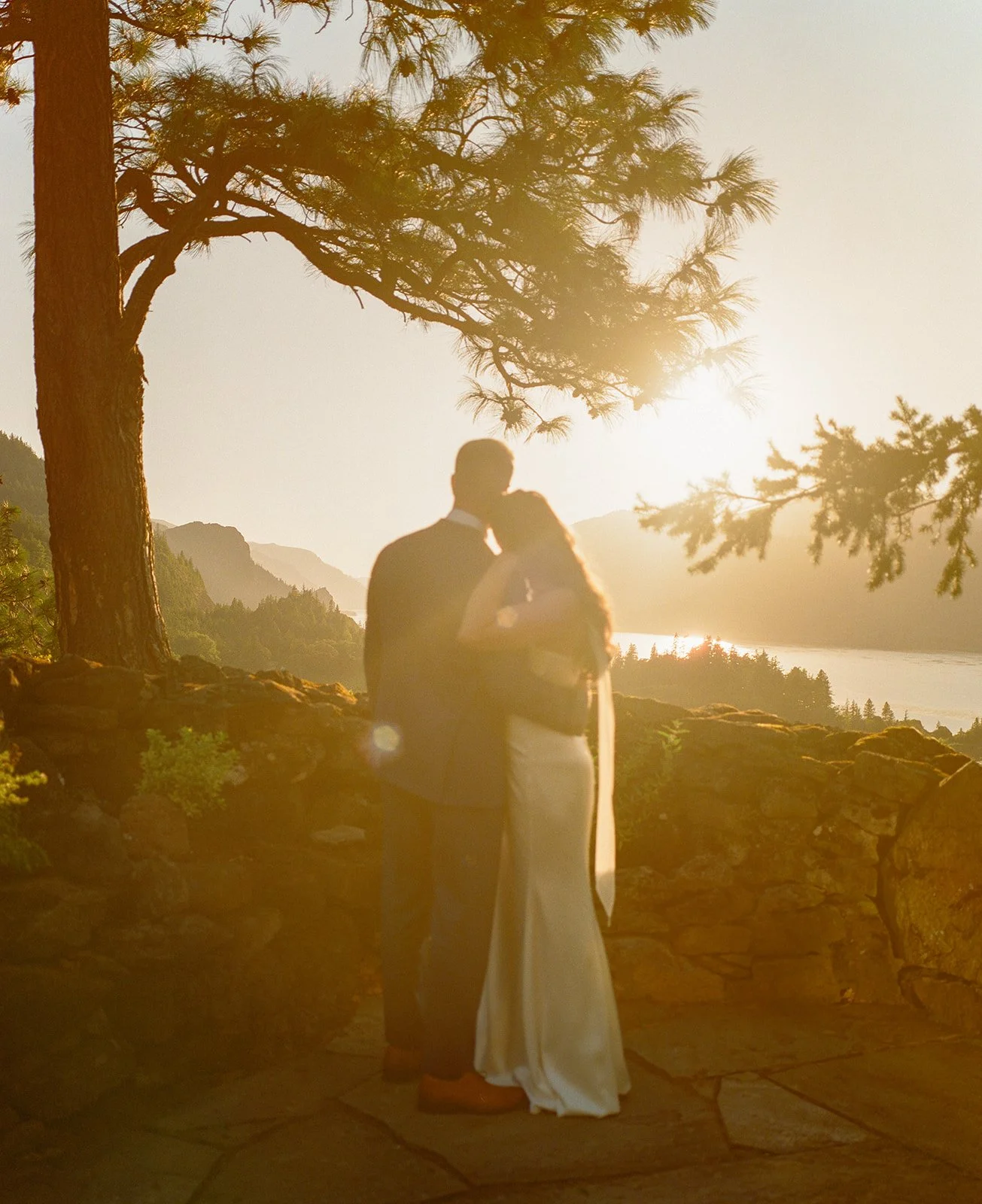 A bride and groom posing for golden hour wedding photos