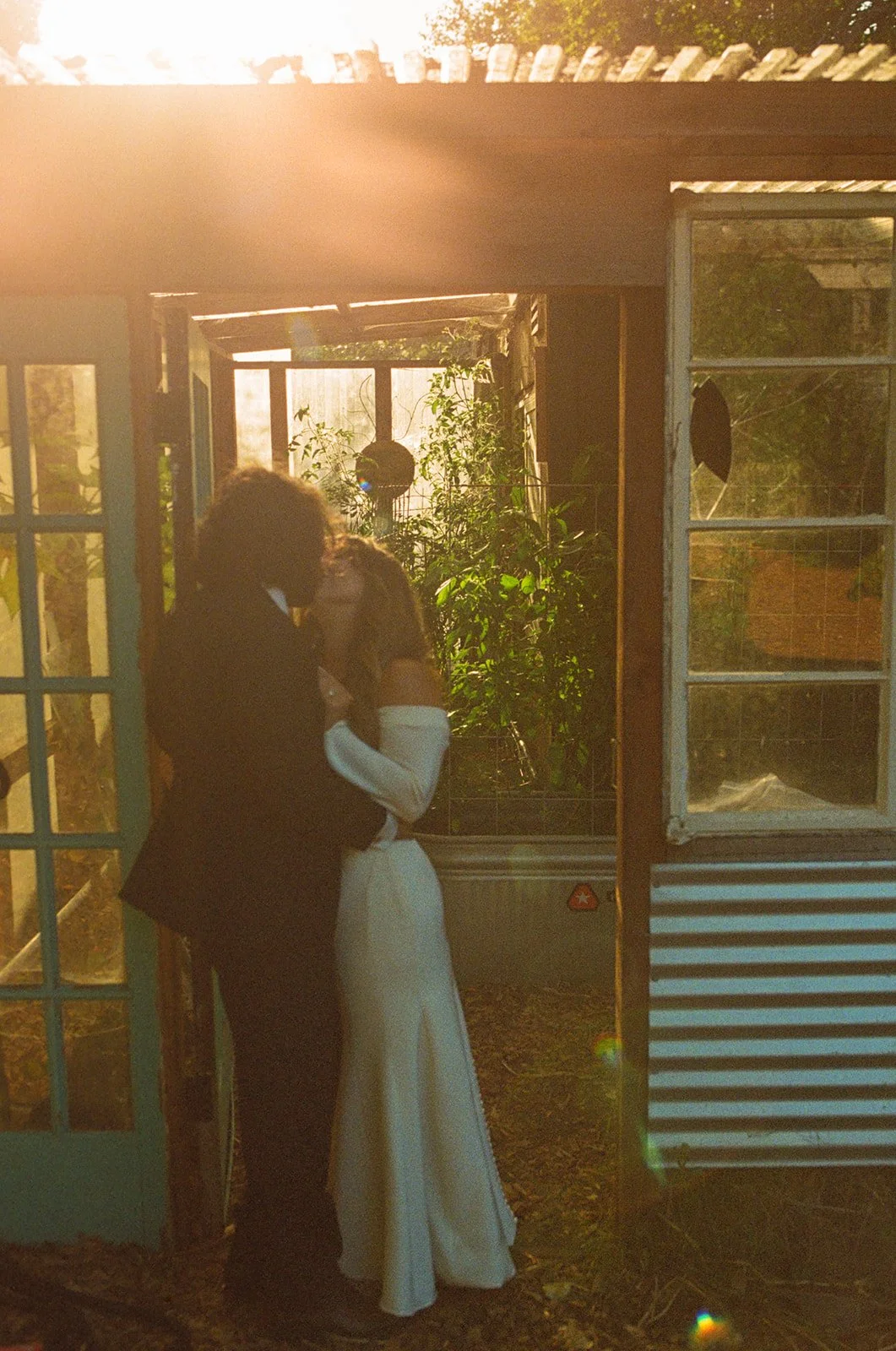 A bride and groom taking sunset wedding photos at their restaurant wedding