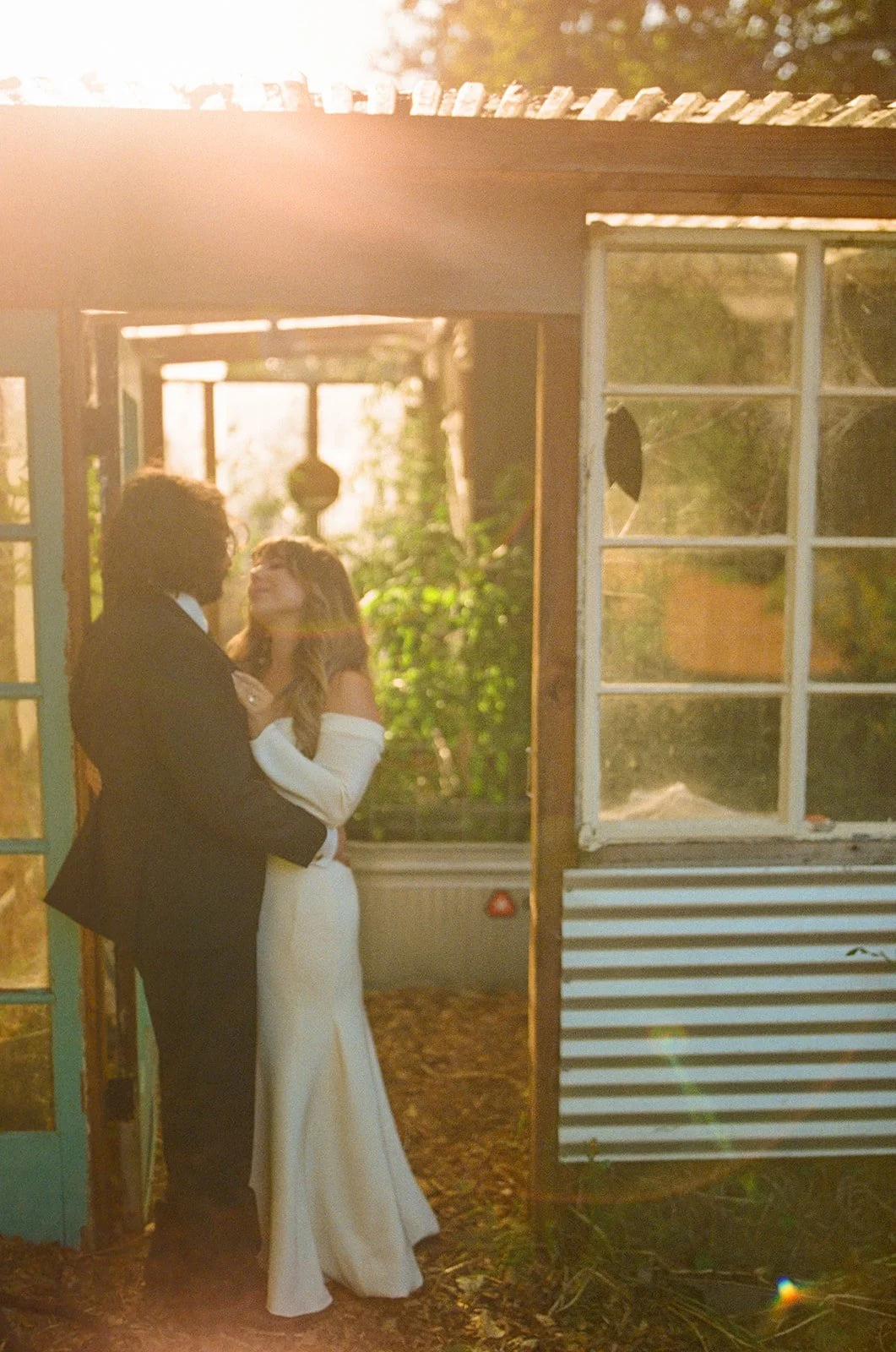 A bride and groom taking sunset wedding photos at their restaurant wedding