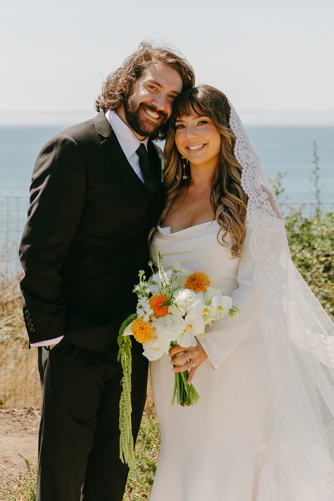 A bride and groom taking wedding portraits