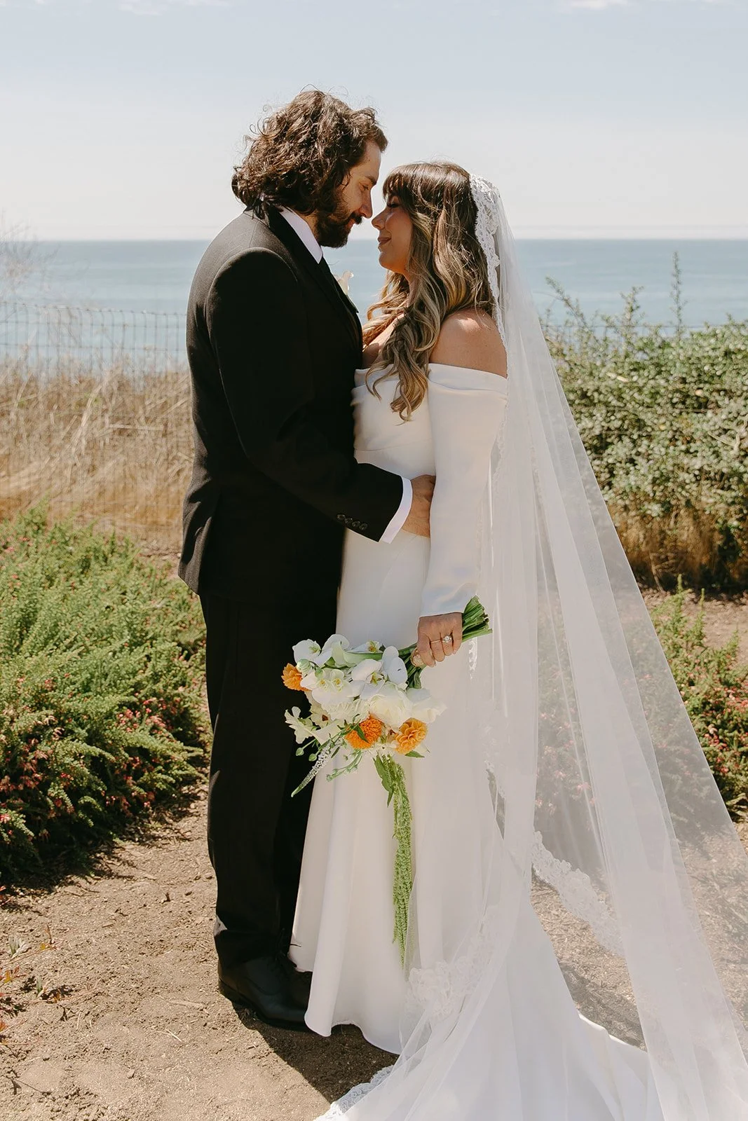 A bride and groom taking wedding portraits