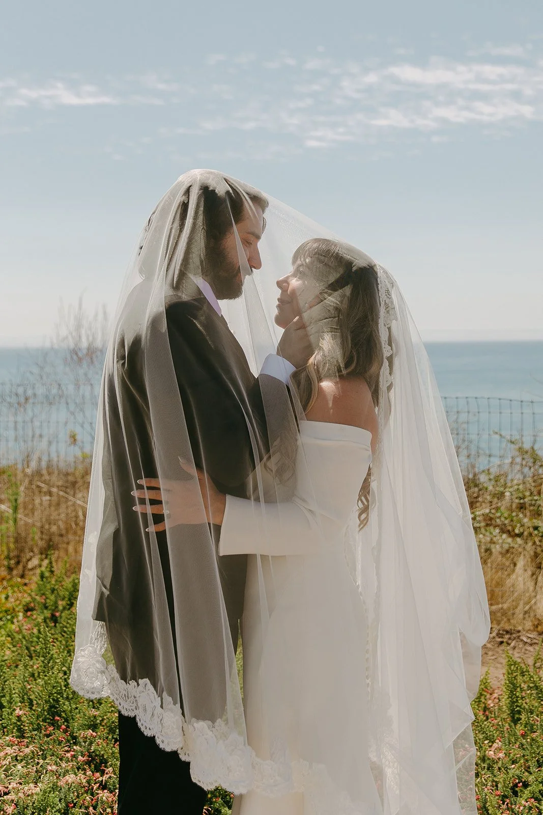 A bride and groom taking wedding portraits