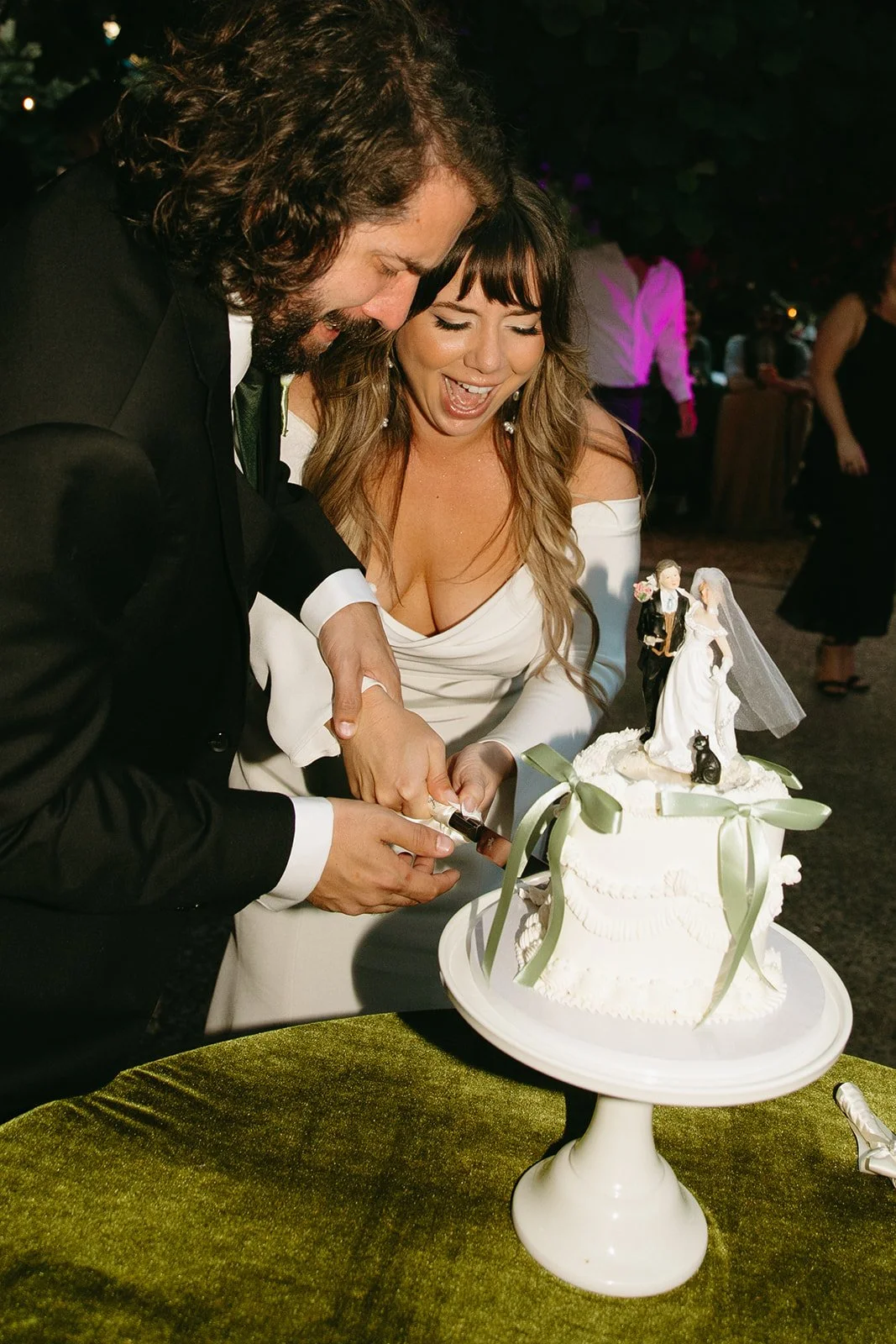 A bride and groom during a cake cutting