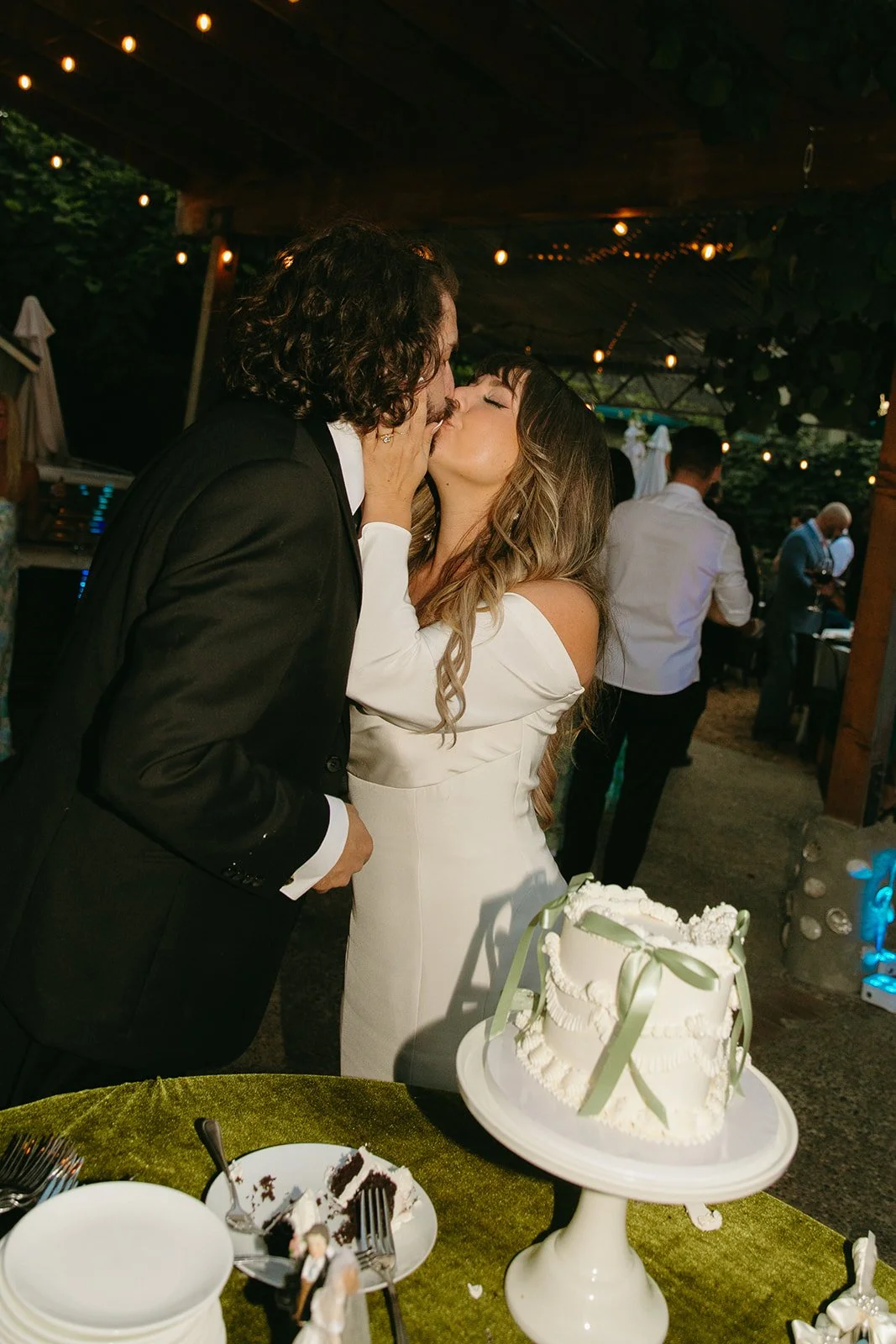 A bride and groom during a cake cutting
