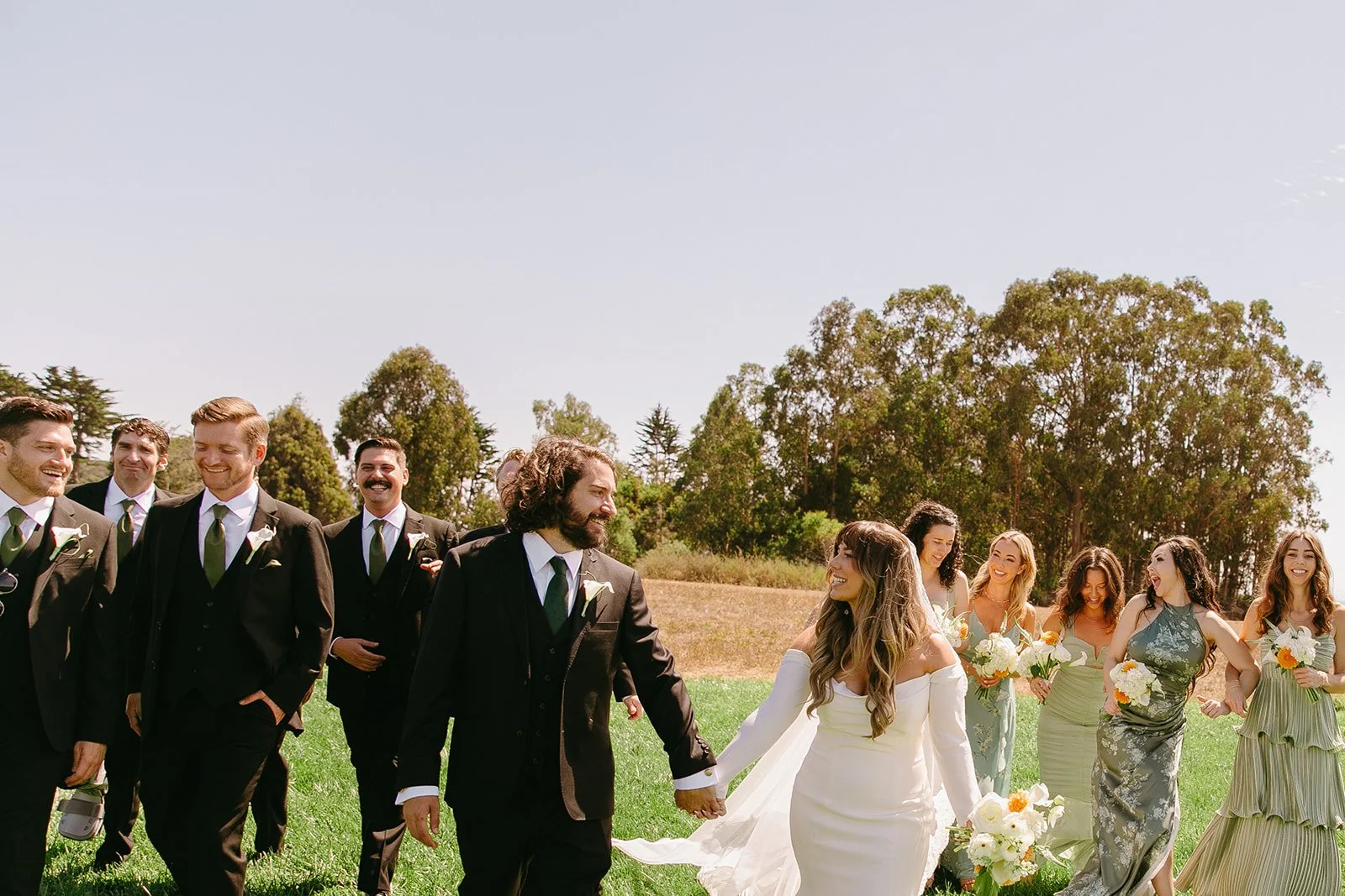 A wedding party cheering in photos
