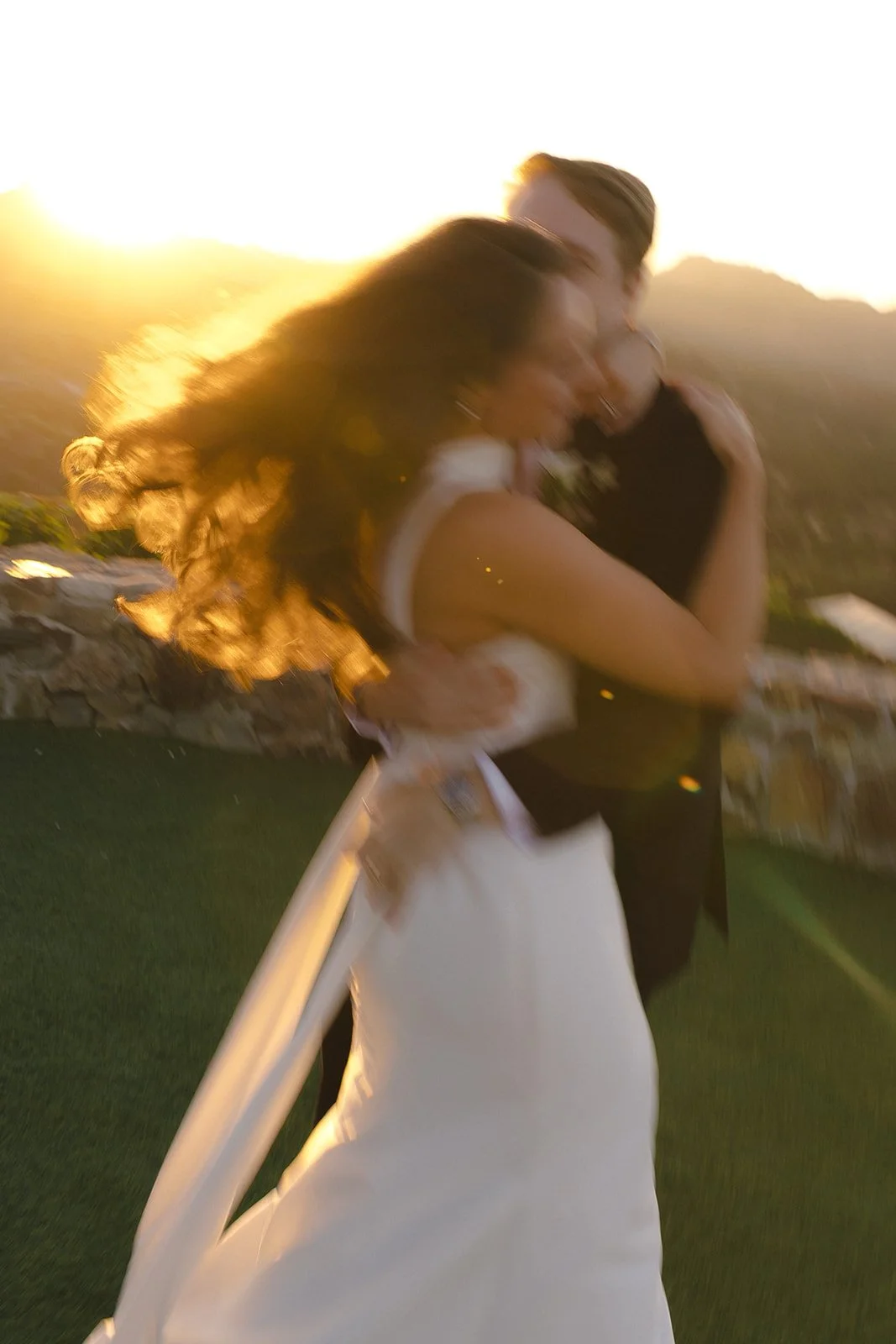 A couple taking sunset wedding photos