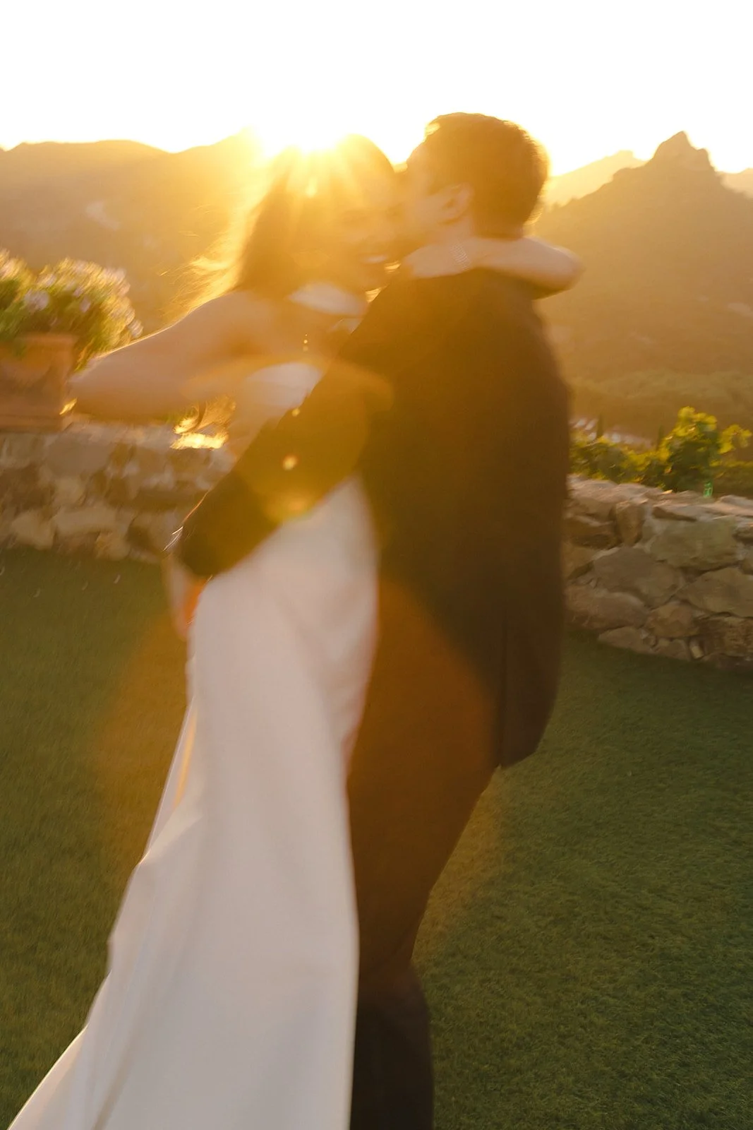A couple taking sunset wedding photos