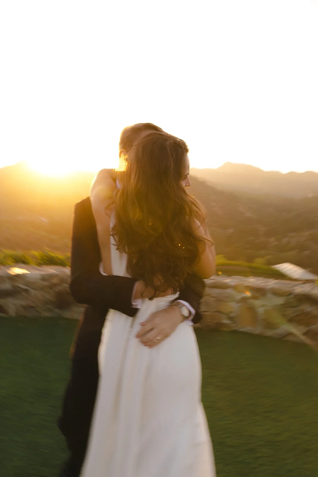 A couple taking sunset wedding photos