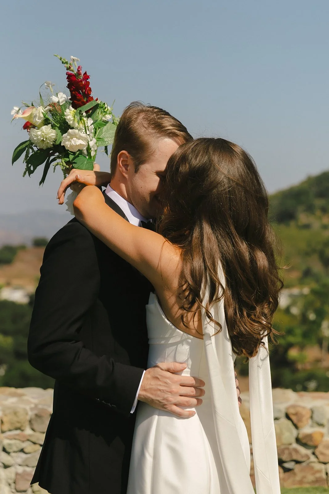A bride and groom posing for wedding photos