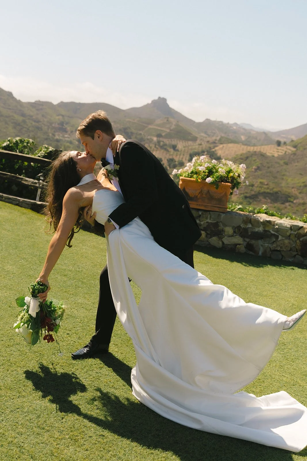 A bride and groom posing for wedding photos