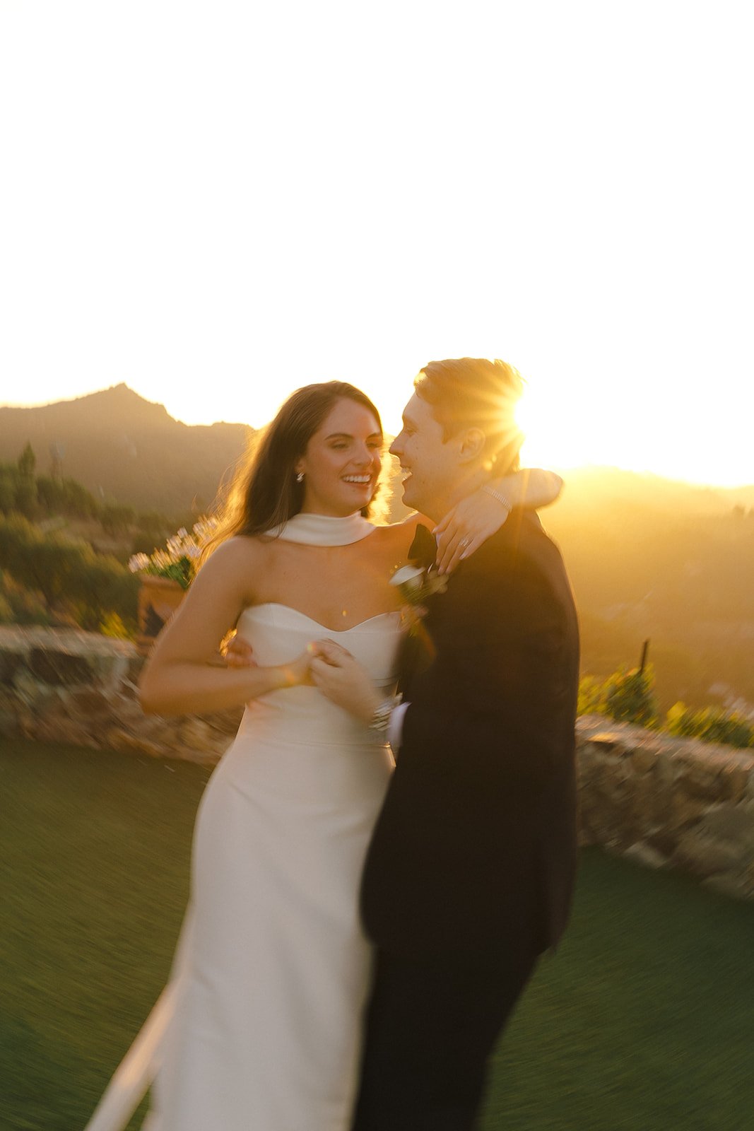 A couple posing for sunset wedding photos at Cielo FArms