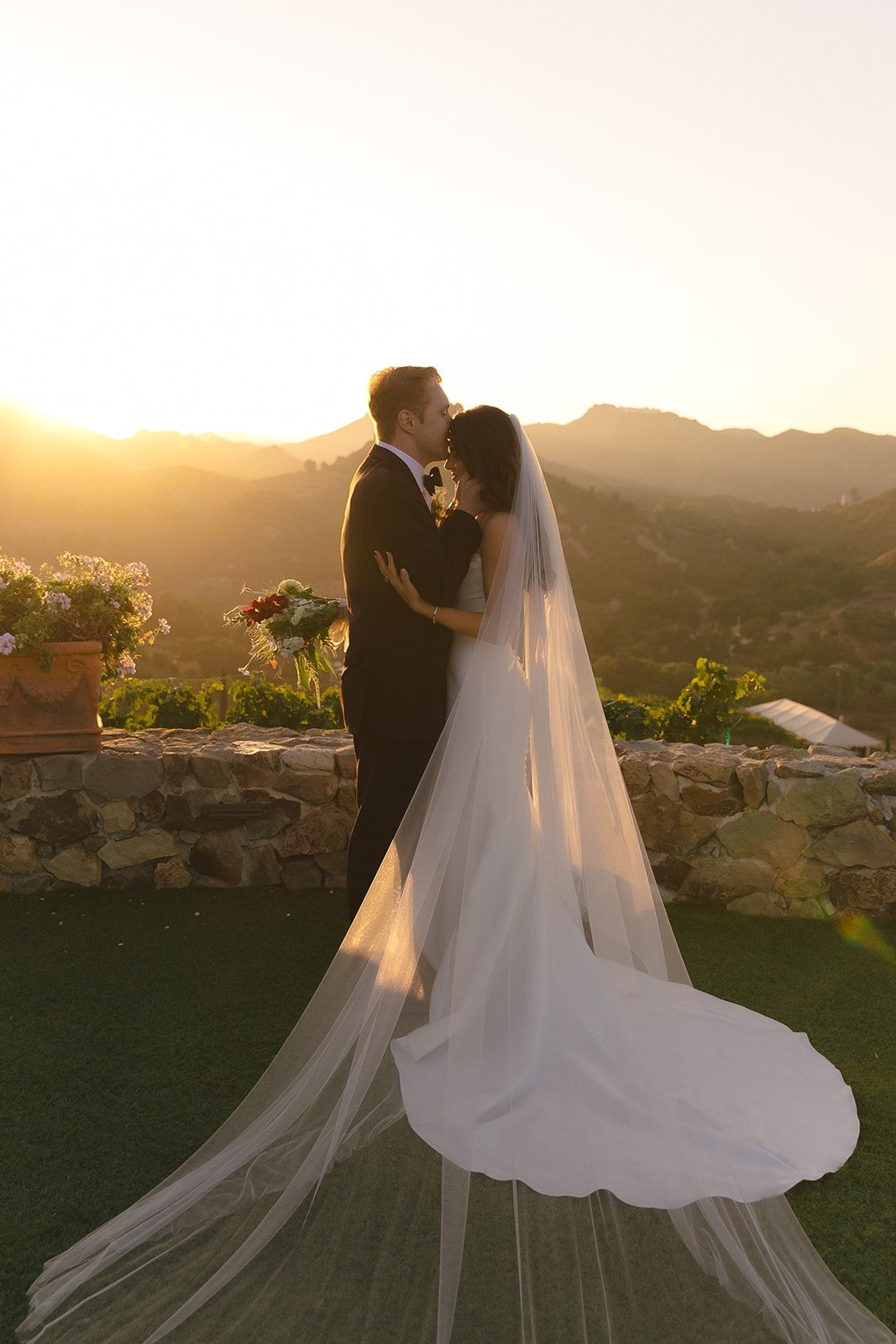 A couple posing for sunset wedding photos at Cielo FArms