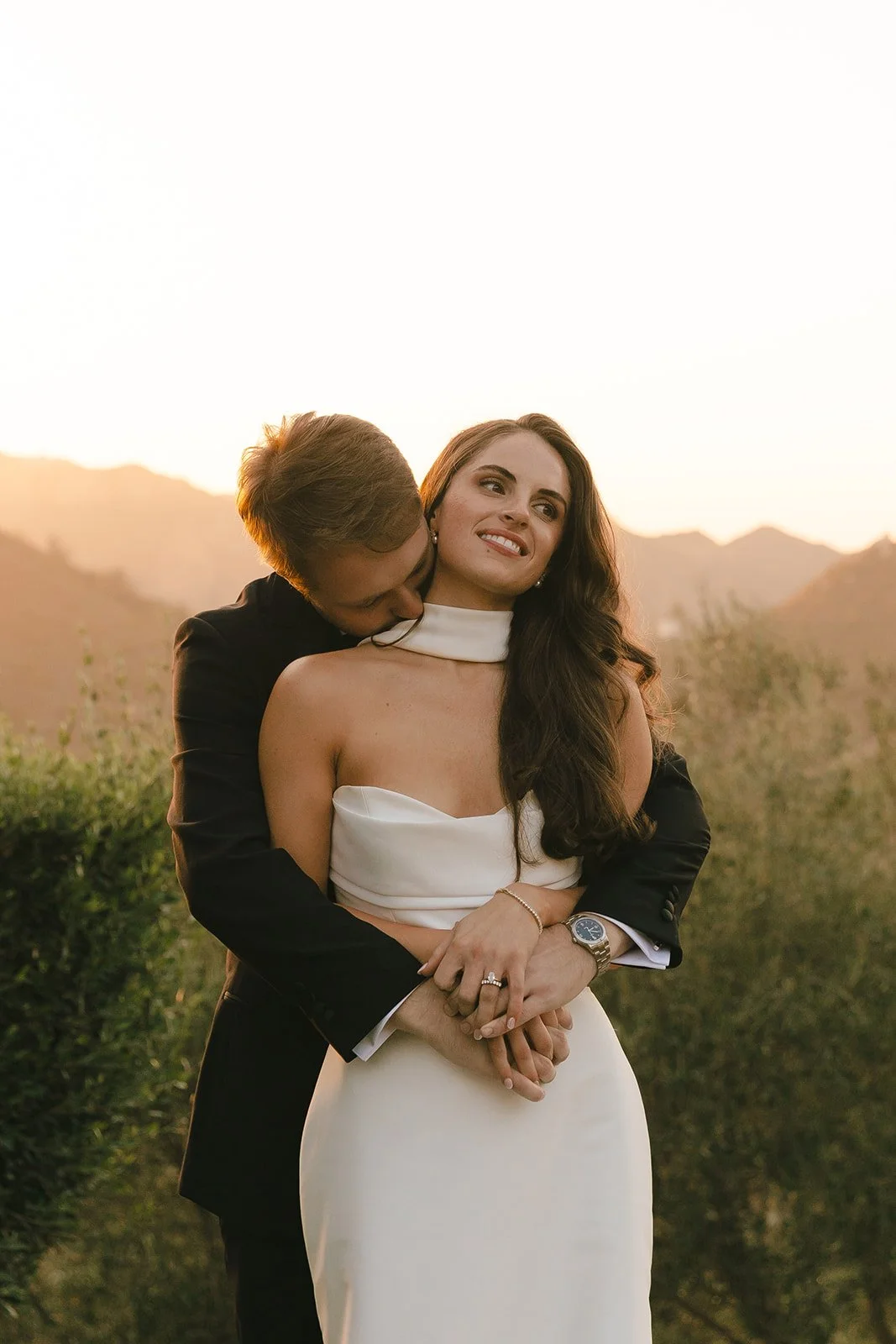 A couple posing for sunset wedding photos at Cielo FArms