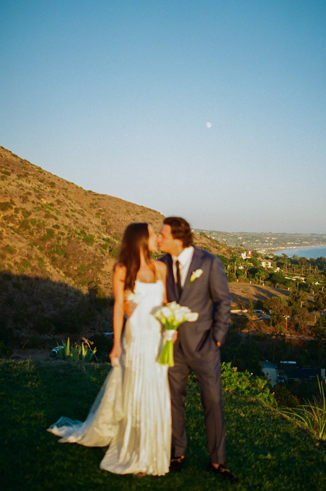 A bride and groom posing for wedding photos at malibu sea view estate