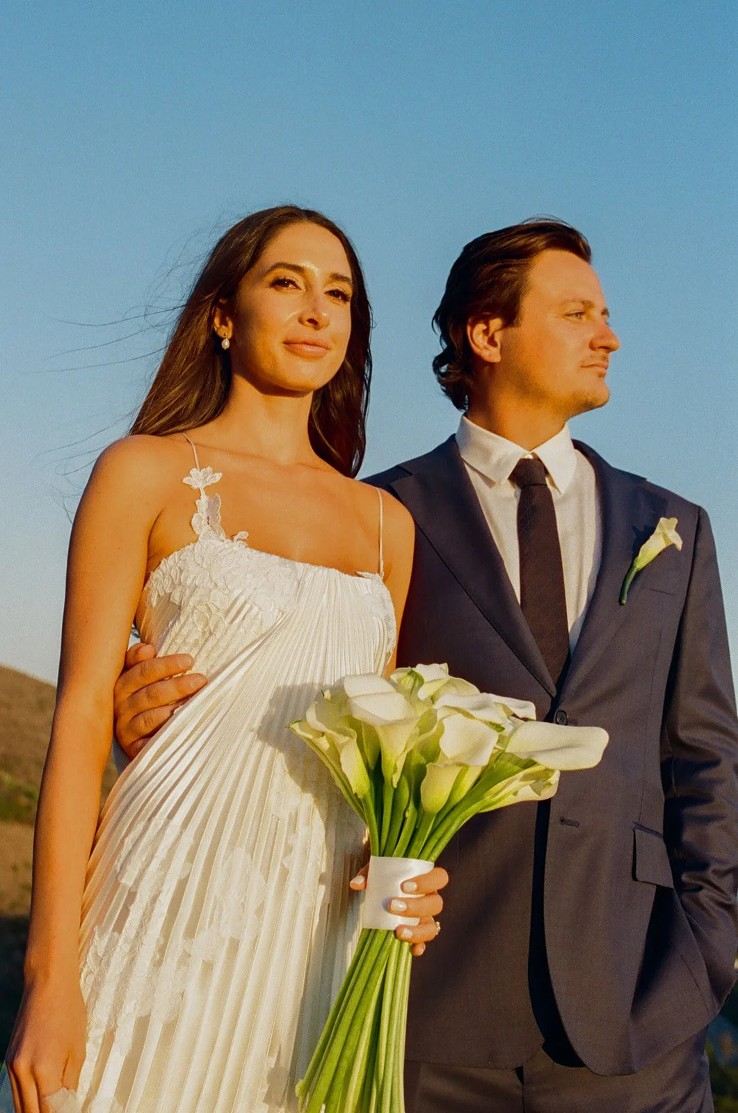 A bride and groom posing for wedding photos