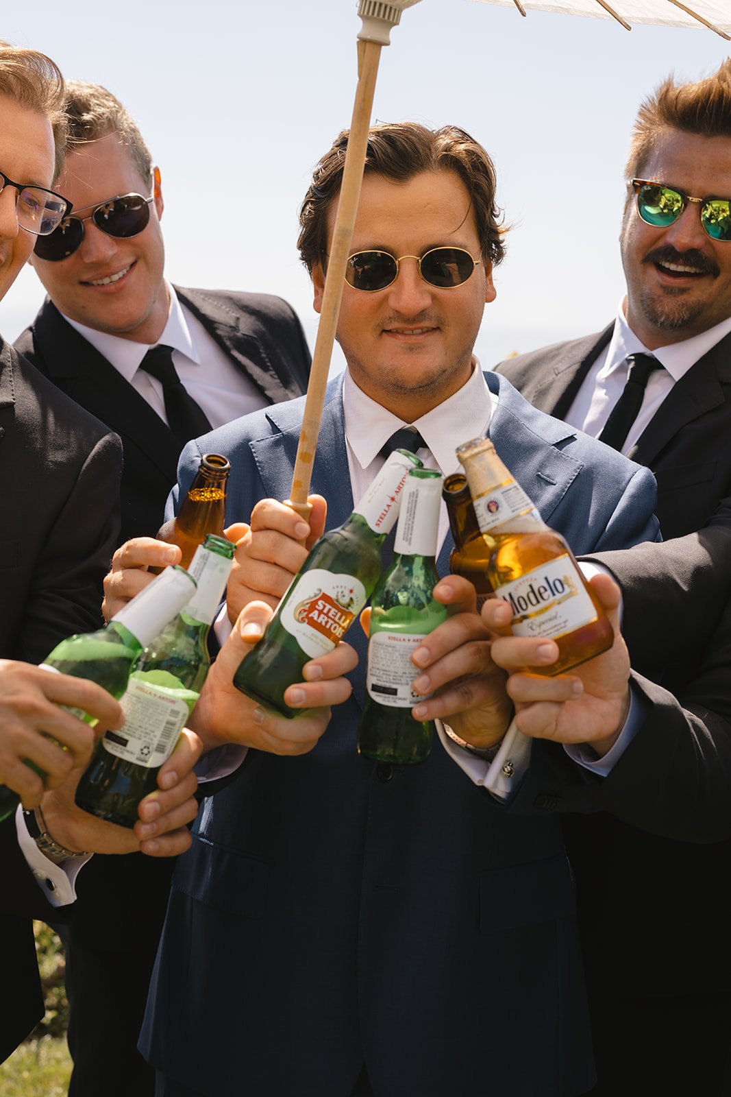 Groomsmen clinking beers