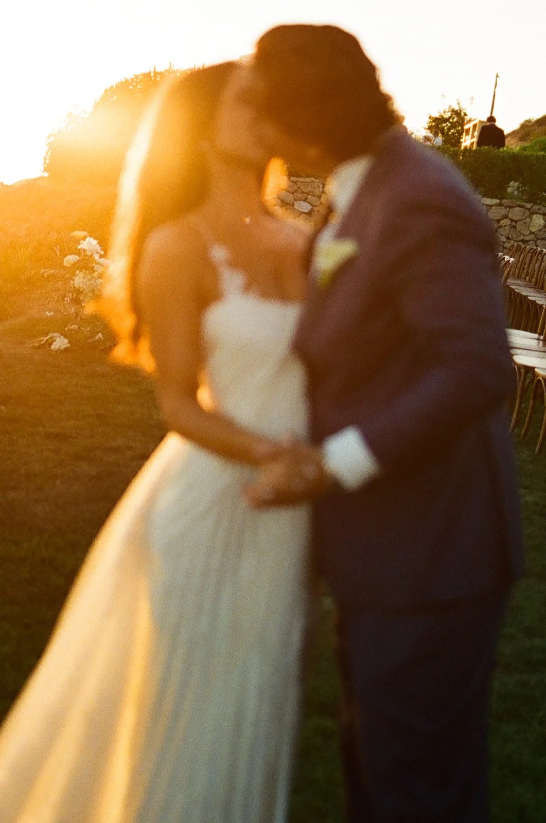 A bride and groom posing for sunset wedding photos
