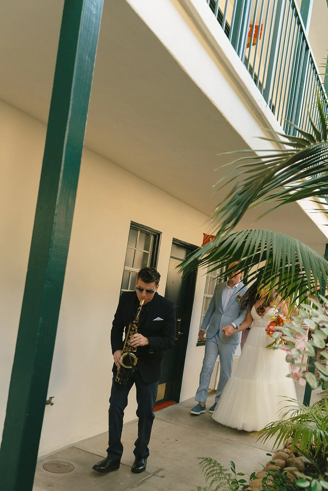 A bride and groom walking in a second line after their Lafayette Hotel wedding ceremony