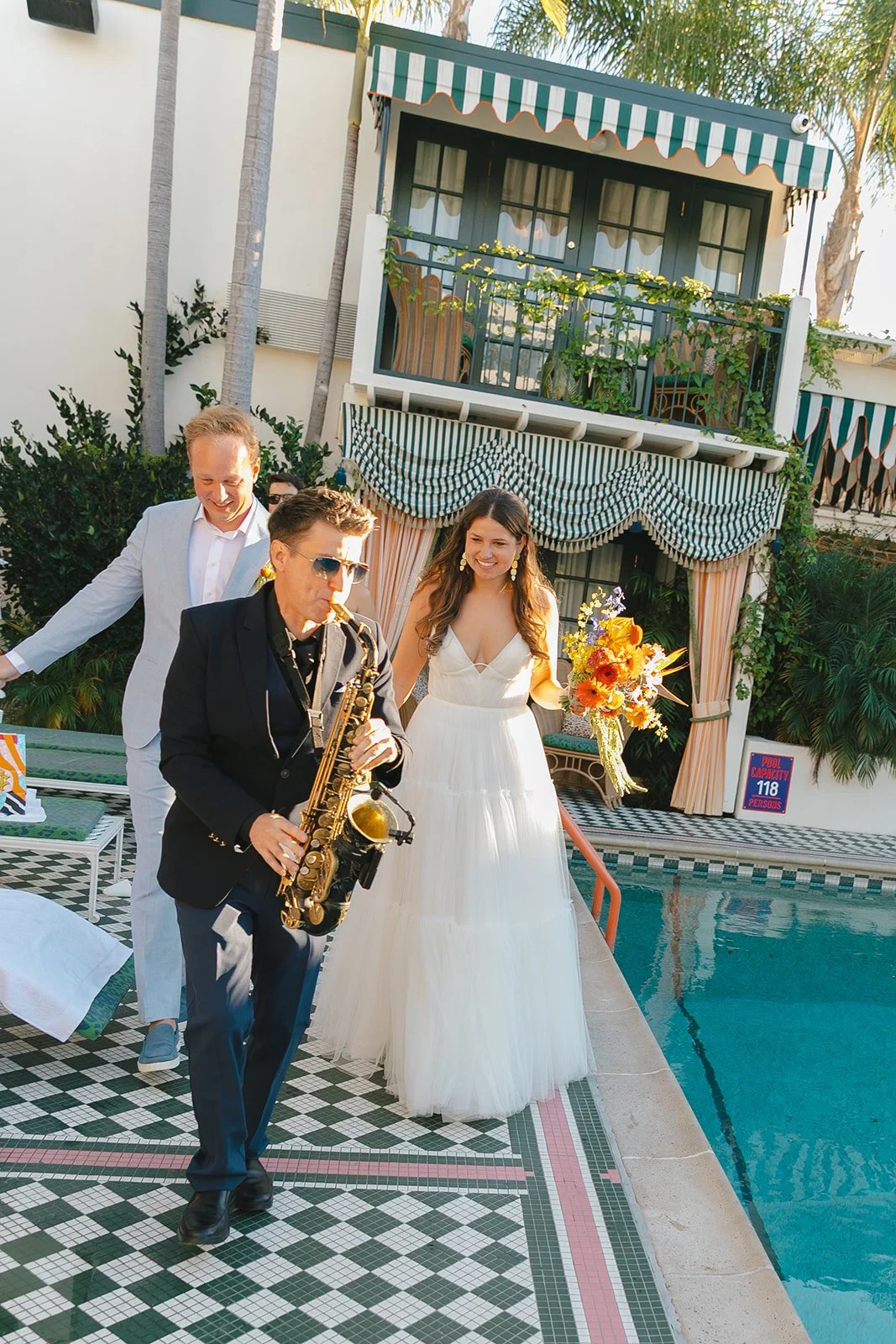 A bride and groom walking in a second line after their Lafayette Hotel wedding ceremony