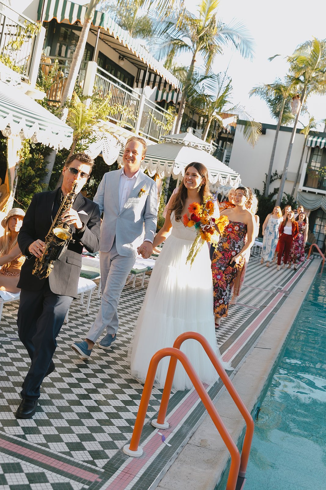 A bride and groom walking in a second line after their Lafayette Hotel wedding ceremony