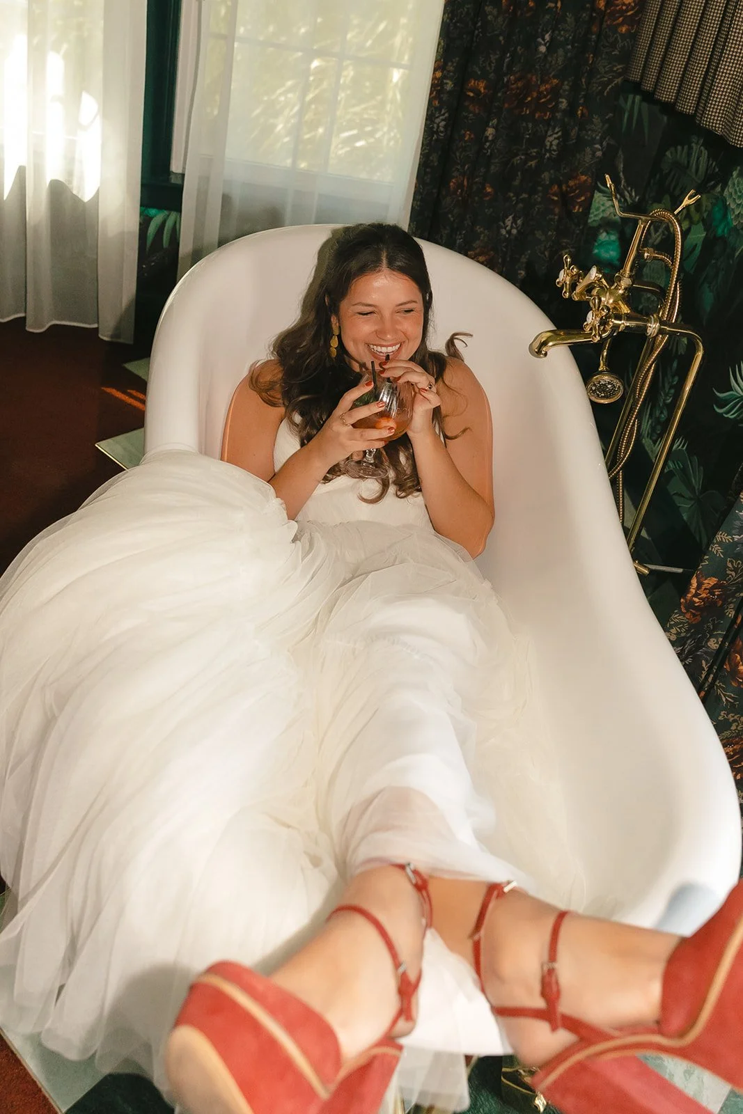 A bride in a bathtub for getting ready wedding photos