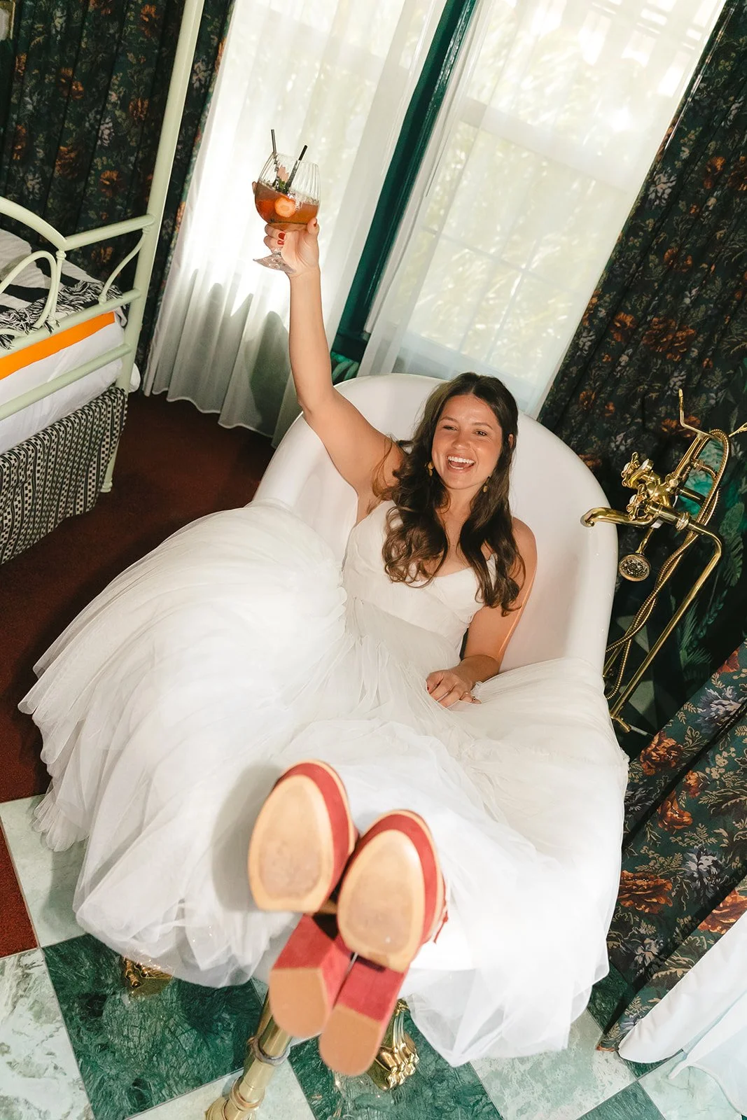 A bride in a bathtub for getting ready wedding photos