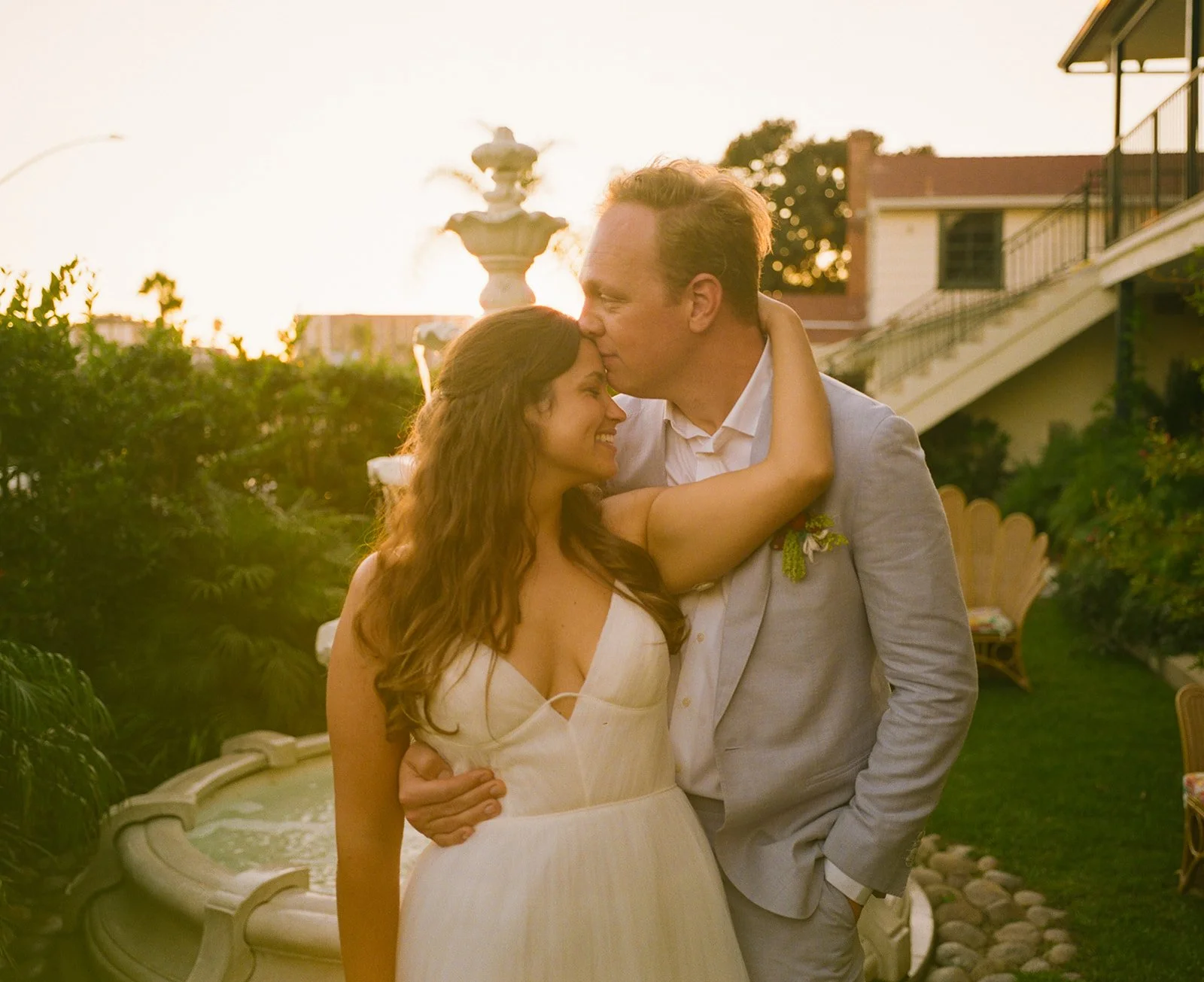 A bride and groom posing for sunset portraits