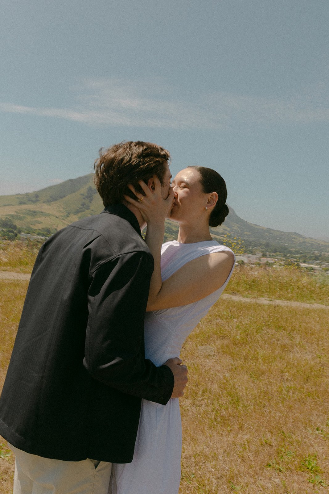A couple taking San Luis Obispo engagement photos on Terrace Hill