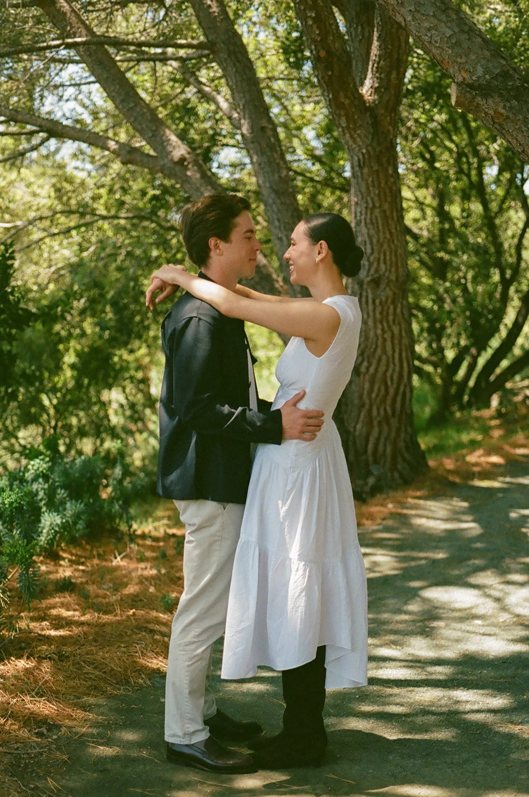 A couple taking engagement photos at Cal Poly Botanical GArdens
