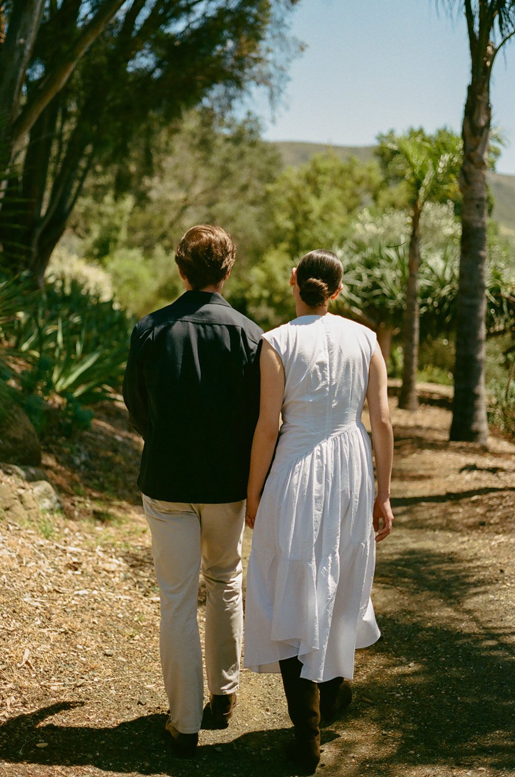 A couple taking engagement photos at Cal Poly Botanical GArdens