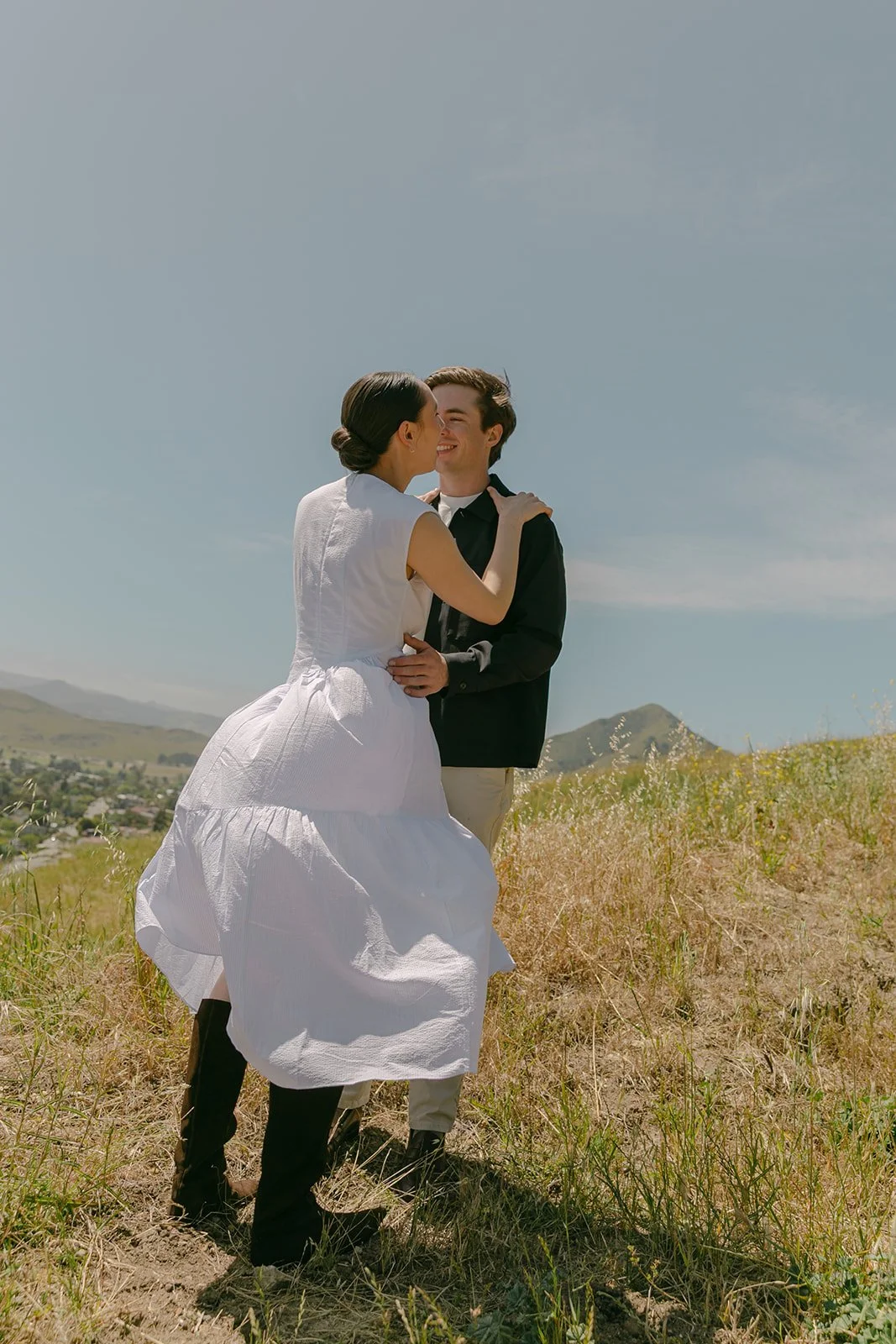 A couple spinning in field engagement photos
