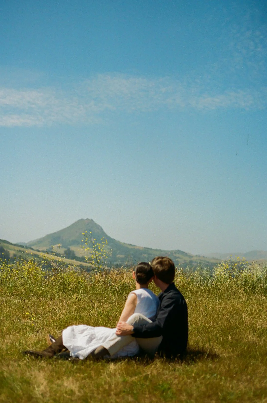 A couple posing for film engagement photos