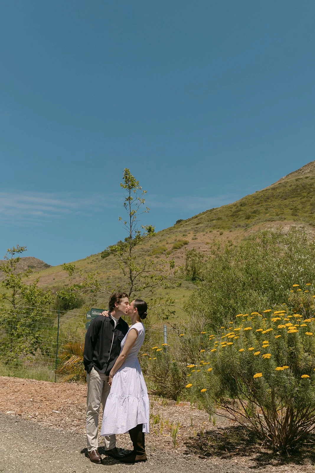 A couple posing for film engagement photos