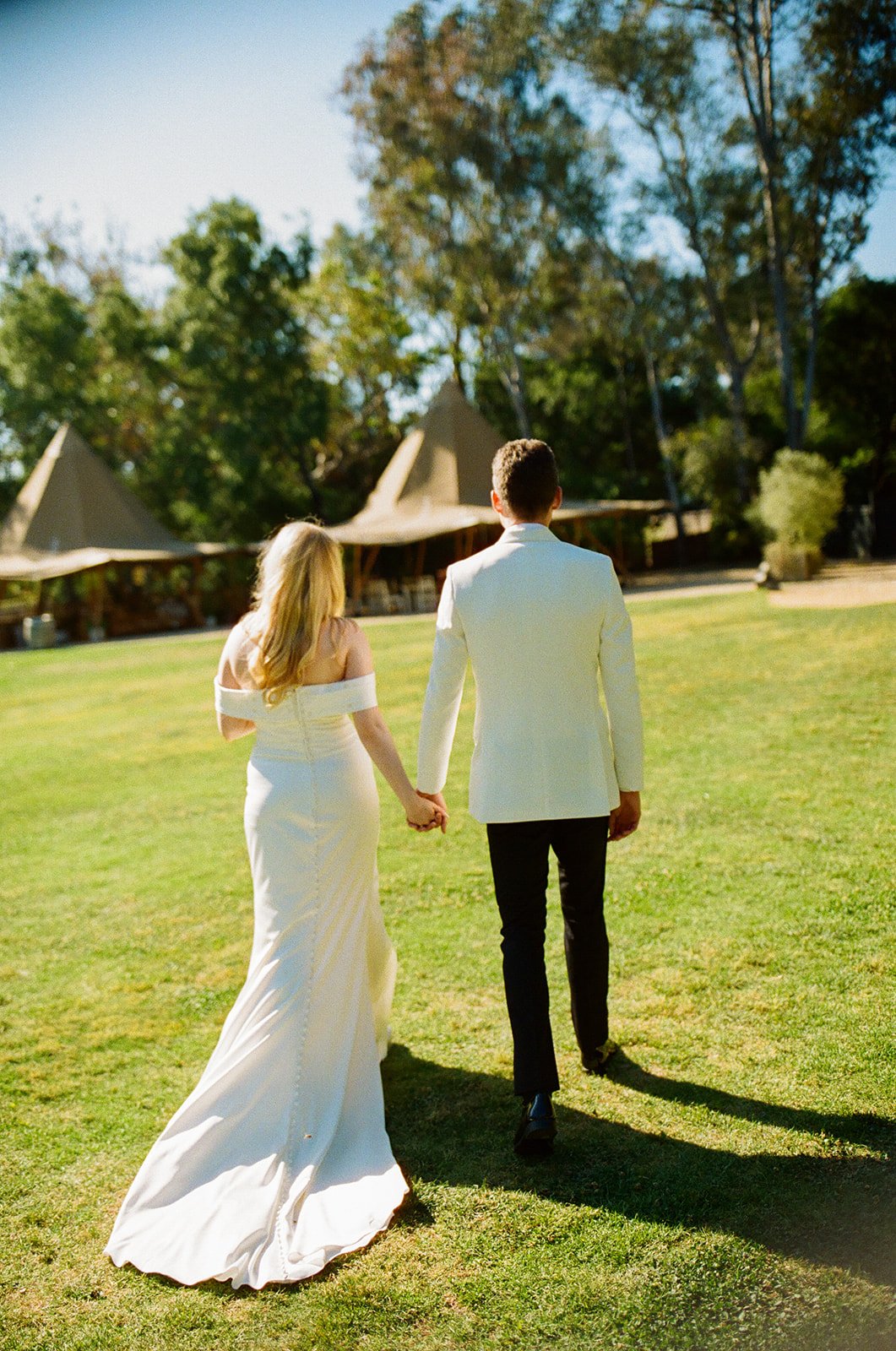A bride and groom walking through their Calamigos Ranch wedding