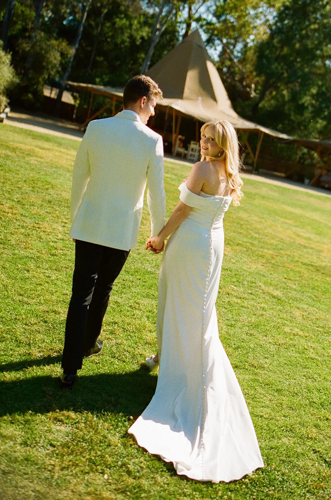 A bride and groom walking through their Calamigos Ranch wedding