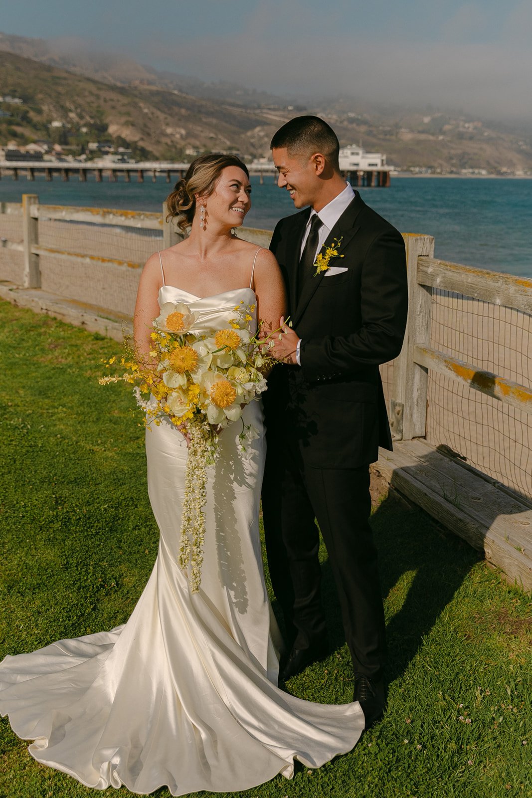 A bride and groom taking wedding portraits at Adamson House