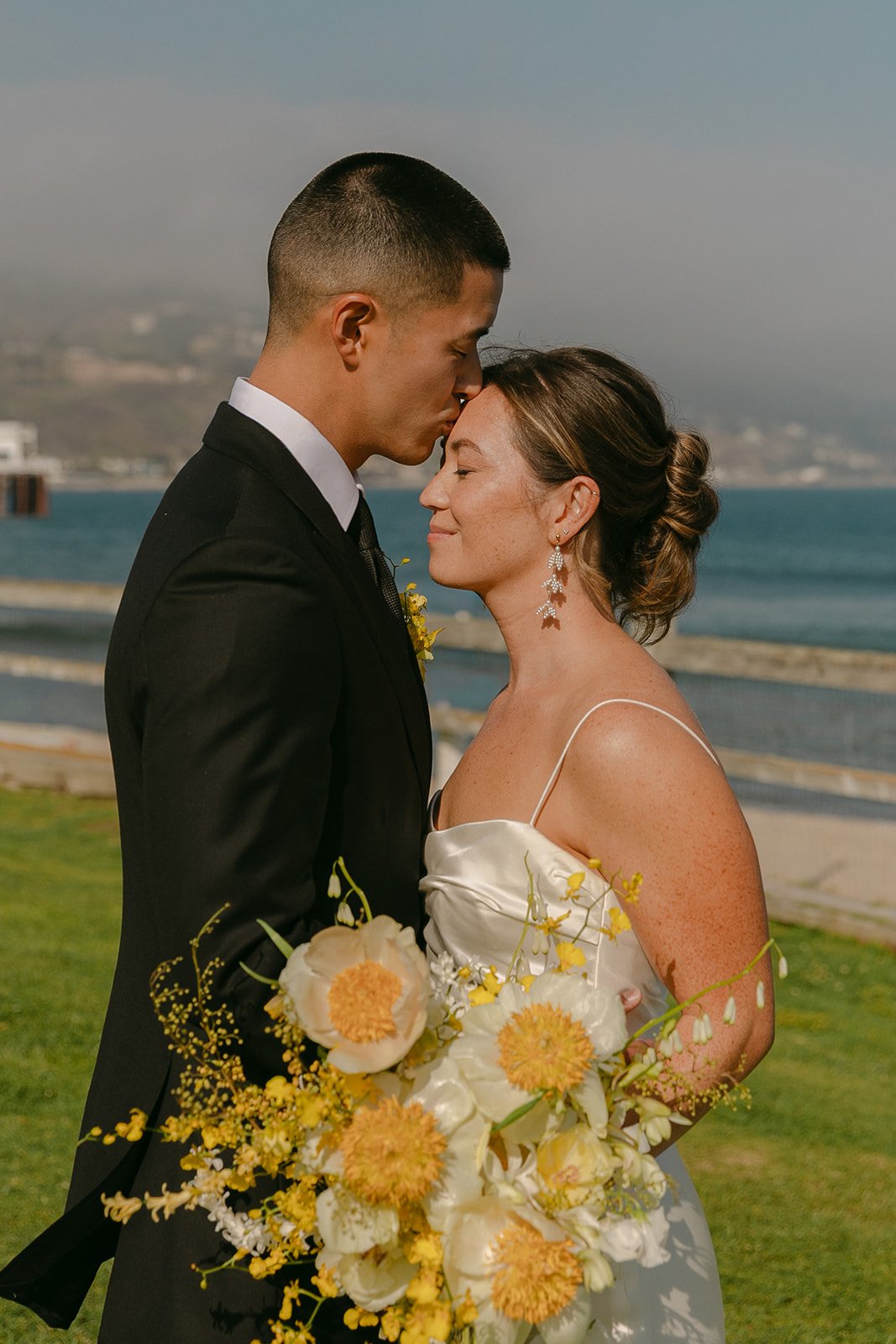 A bride and groom taking wedding portraits at Adamson House