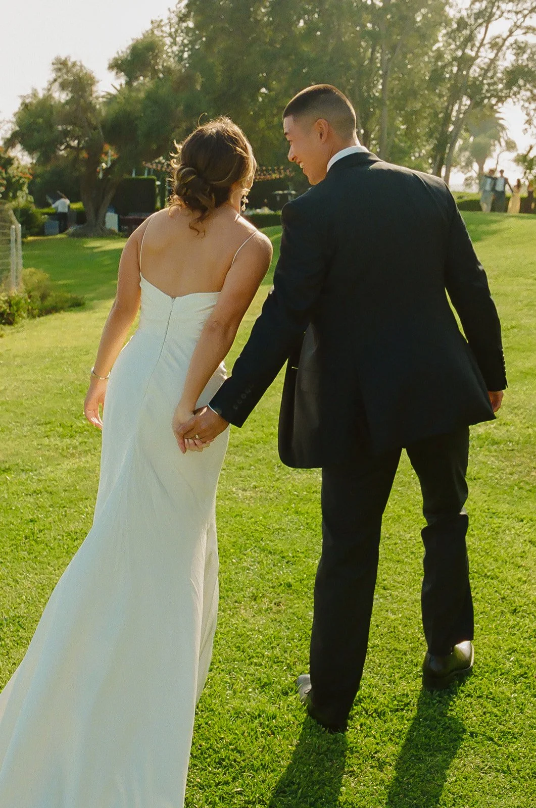 A bride and groom walking through their wedding venue, Adamson House