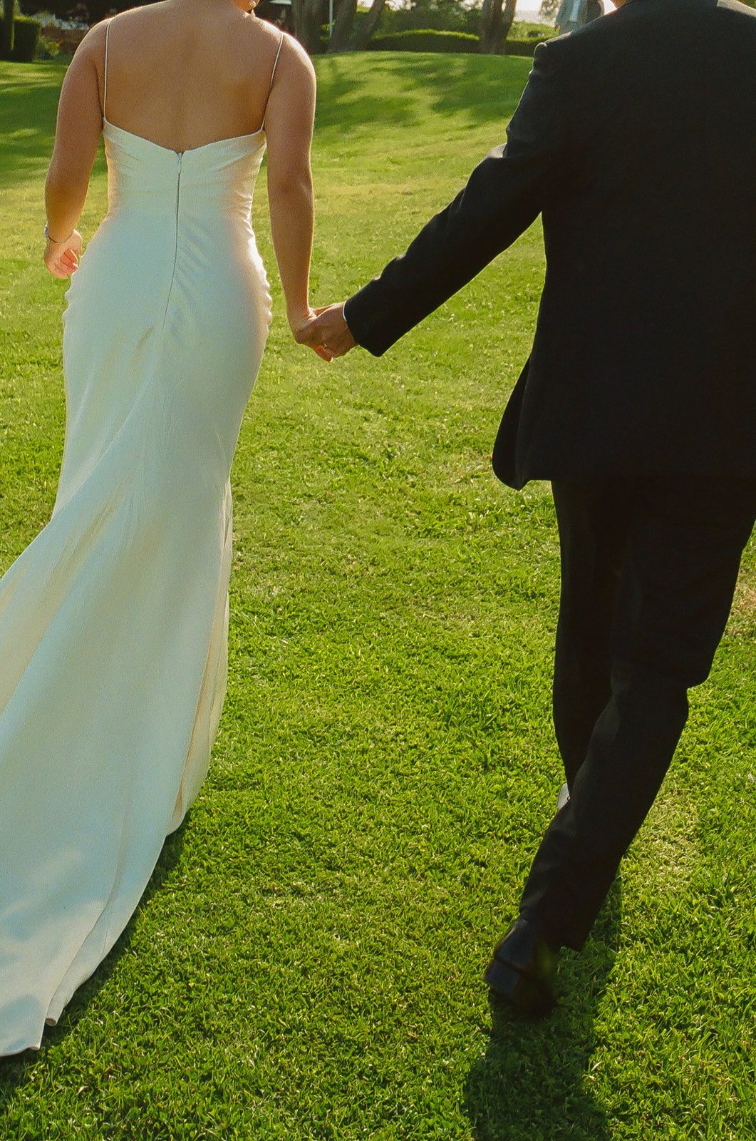 A bride and groom walking through their wedding venue, Adamson House