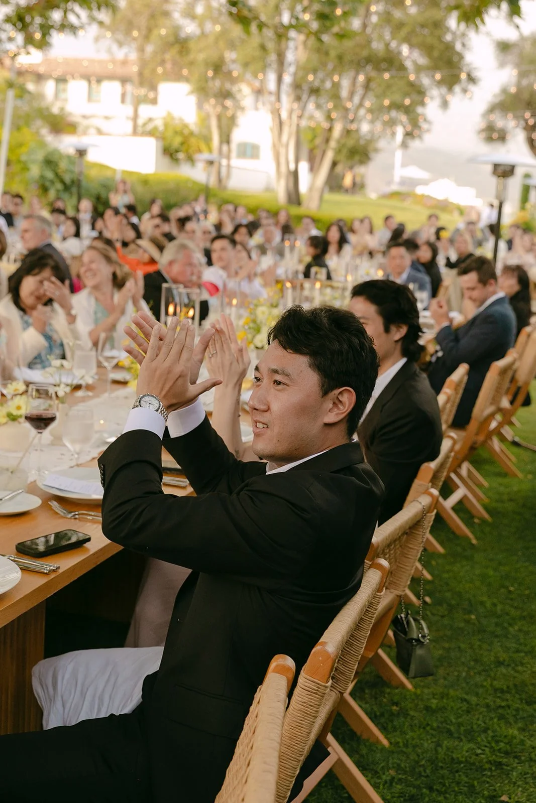 Wedding guests cheering for a bride and groom