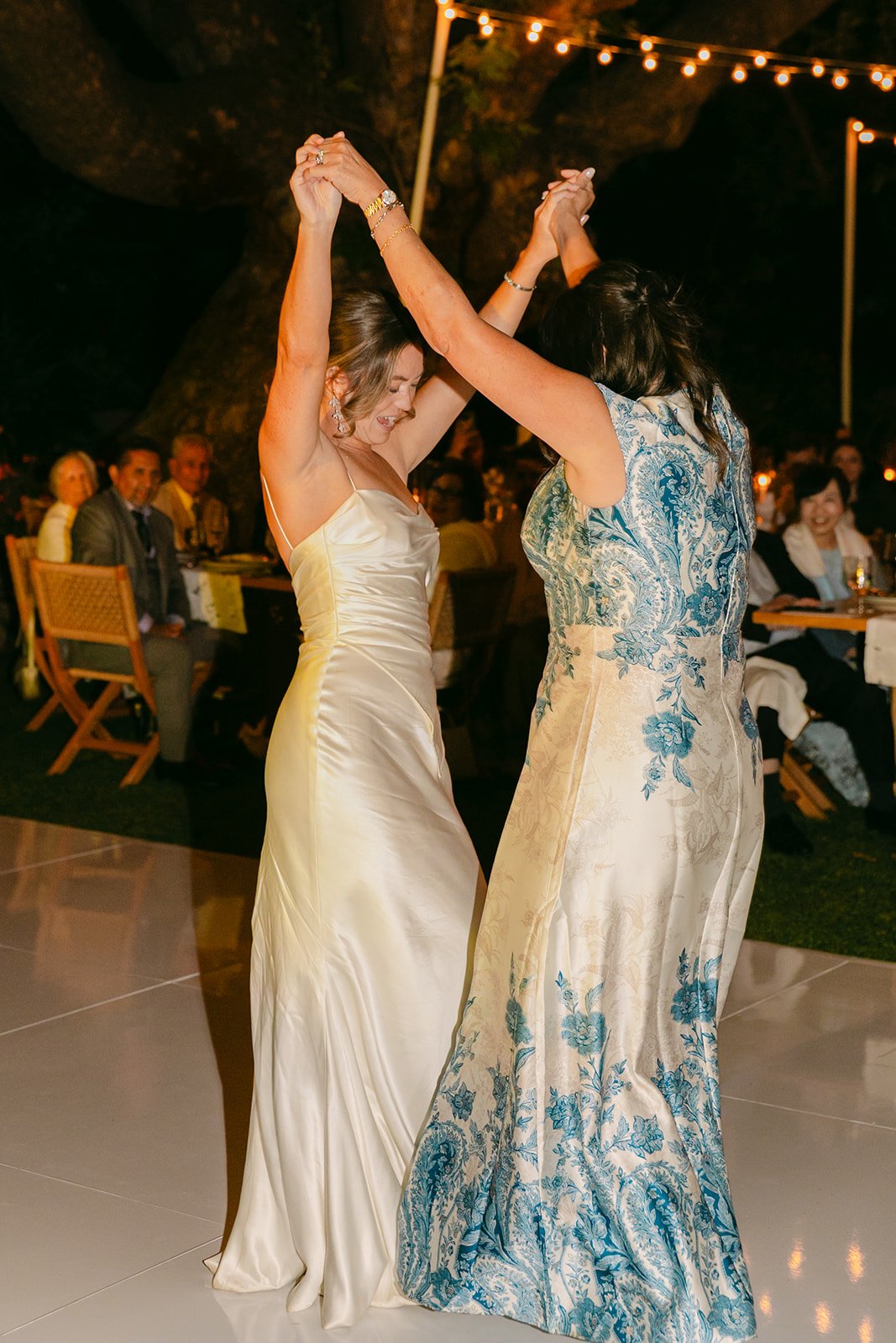 A bride and her mom dancing