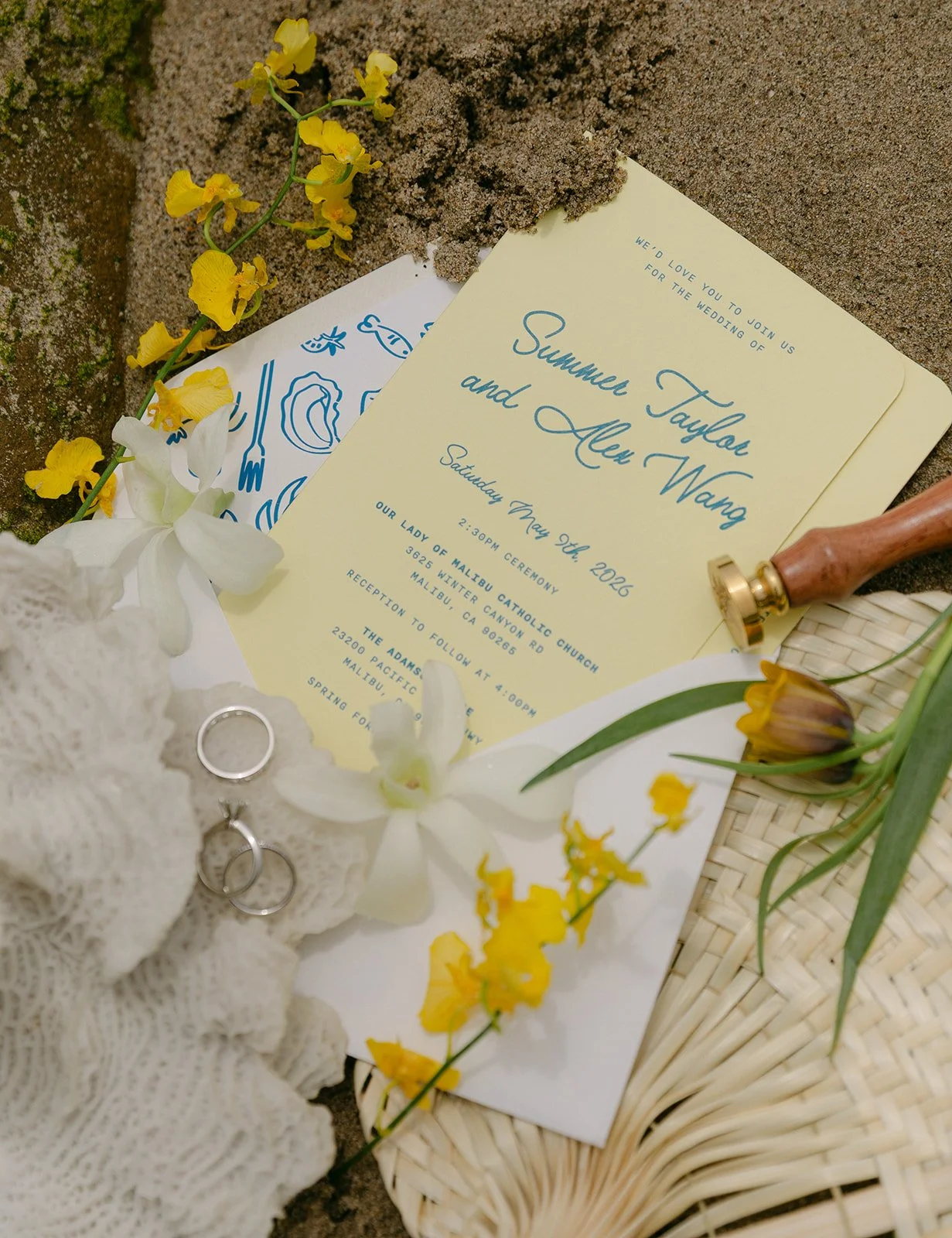A wedding flat lay with invitations for an Adamson House wedding