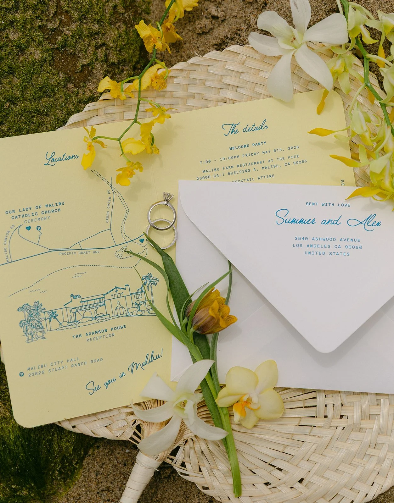 A wedding flat lay with invitations for an Adamson House wedding