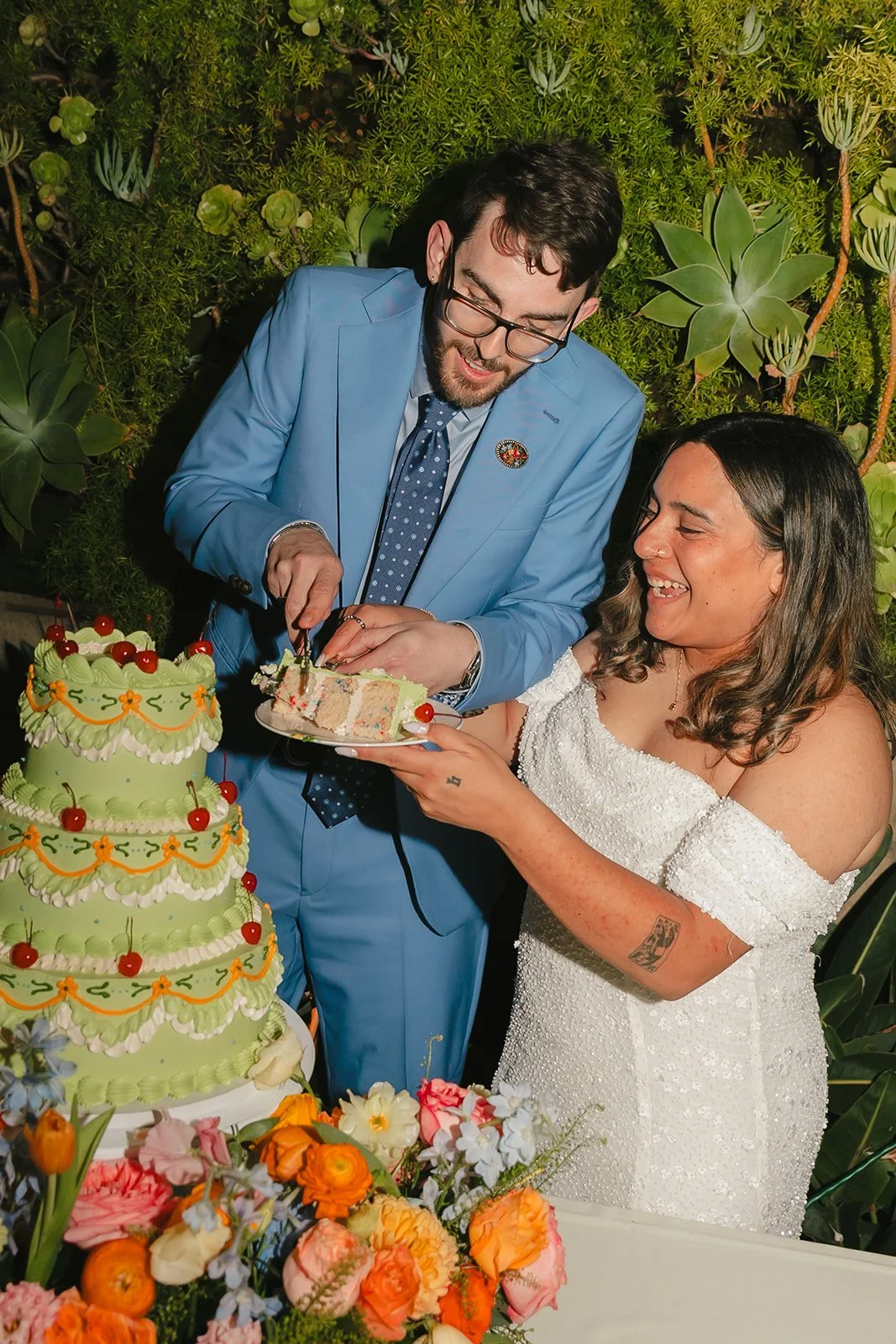 A bride and groom during their cake cutting