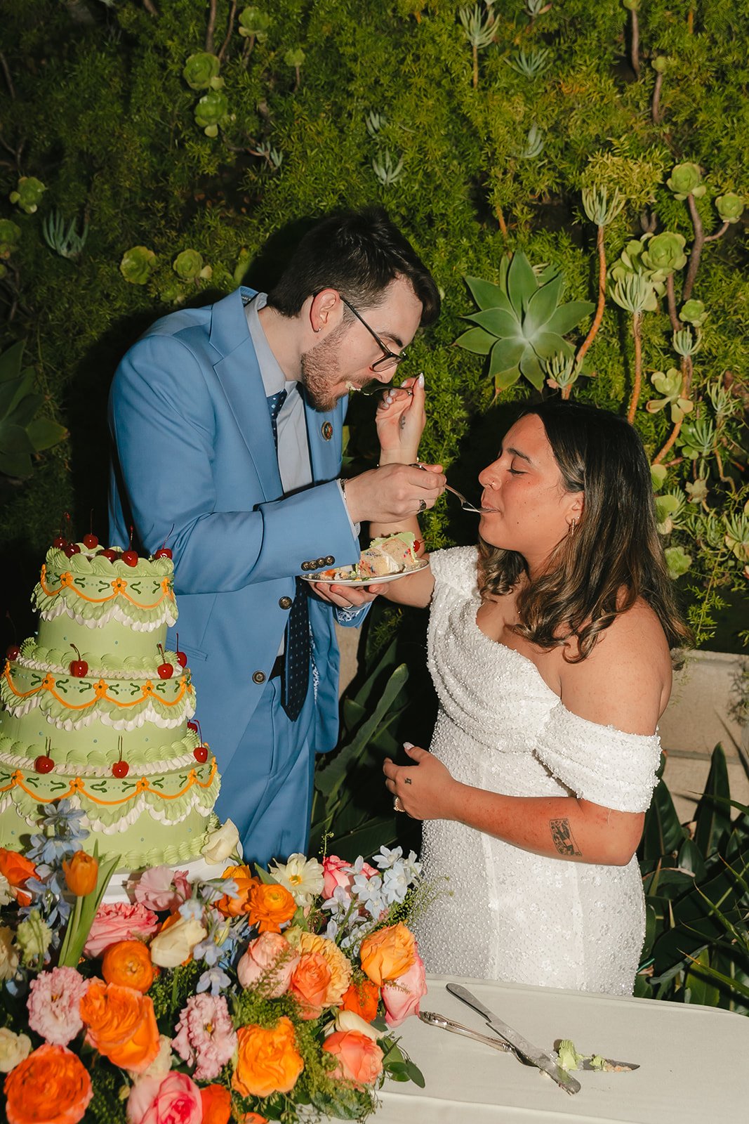 A bride and groom during their cake cutting